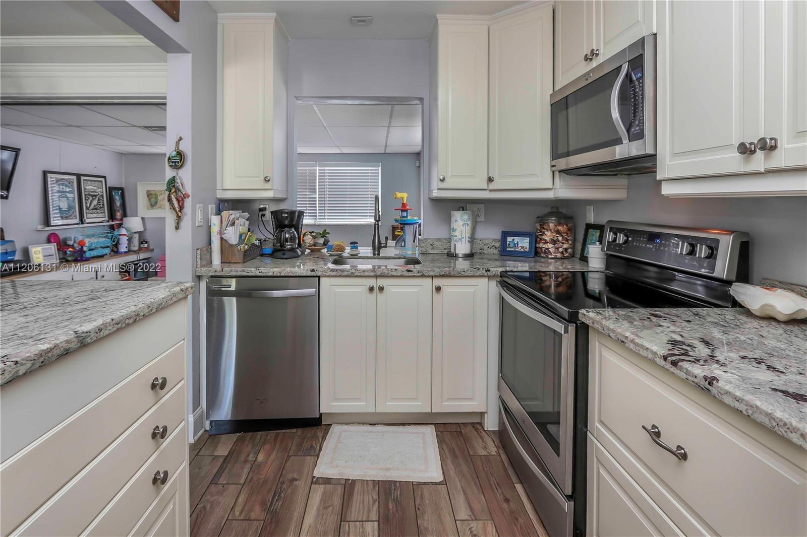 1711 North Park Road Hollywood, FL 33021 - Photo 9 of 29 a kitchen with granite countertop cabinets stainless steel appliances a sink and dishwasher