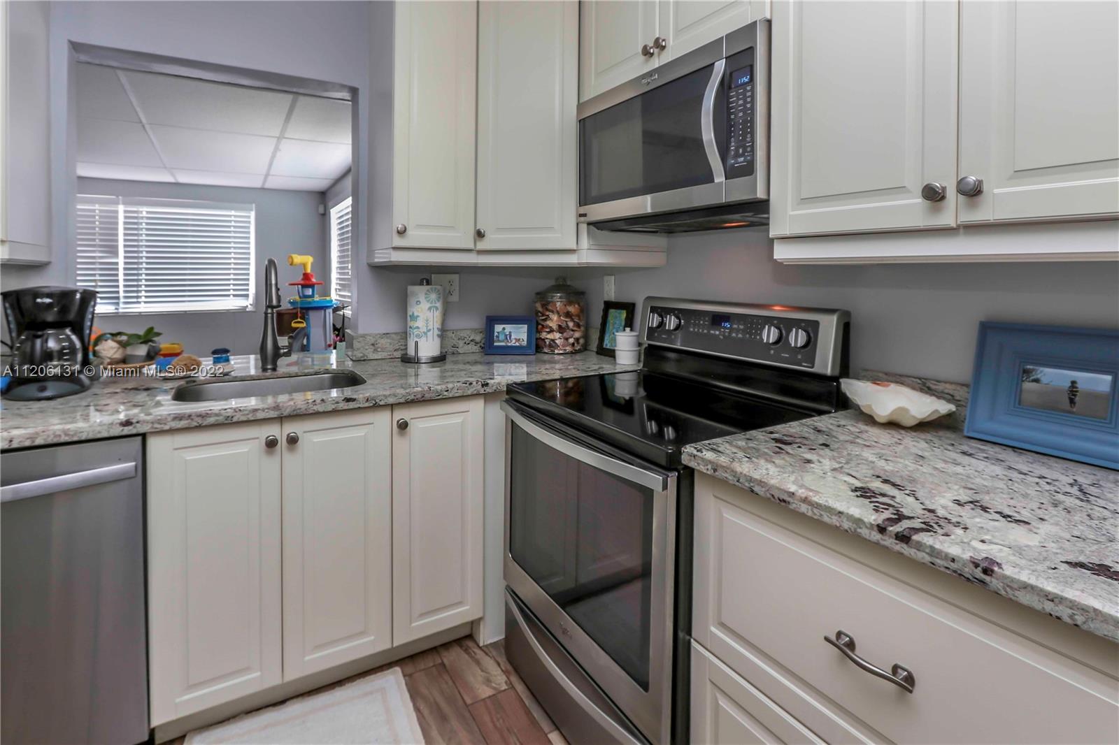 1711 North Park Road Hollywood, FL 33021 - Photo 10 of 29 a kitchen with stainless steel appliances granite countertop a sink stove and microwave