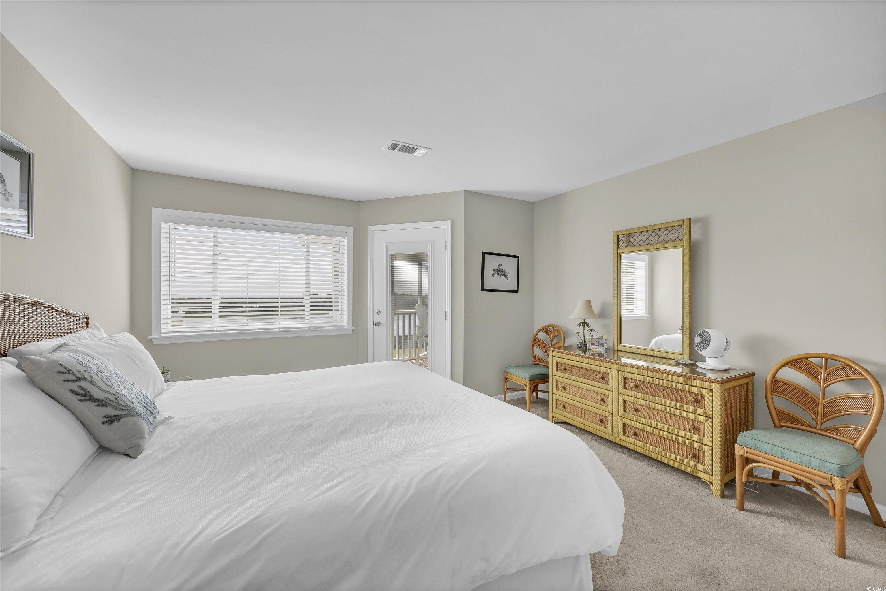 1912 Goose Creek Road Southwest, Unit 4301 Ocean Isle Beach, NC 28469 - Photo 21 of 39 Bedroom featuring light colored carpet and access to outside