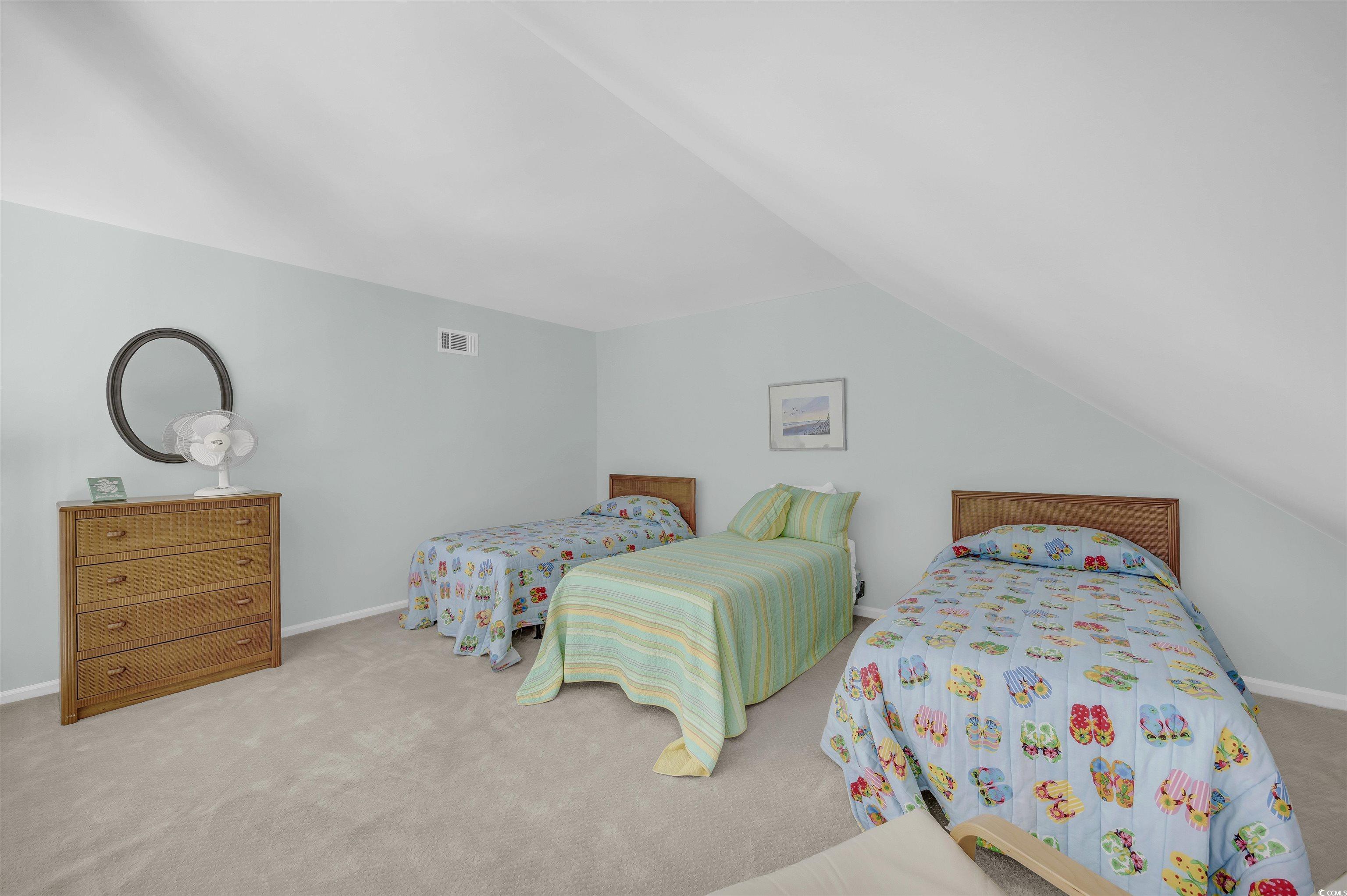 1912 Goose Creek Road Southwest, Unit 4301 Ocean Isle Beach, NC 28469 - Photo 25 of 39 Bedroom with carpet floors and vaulted ceiling