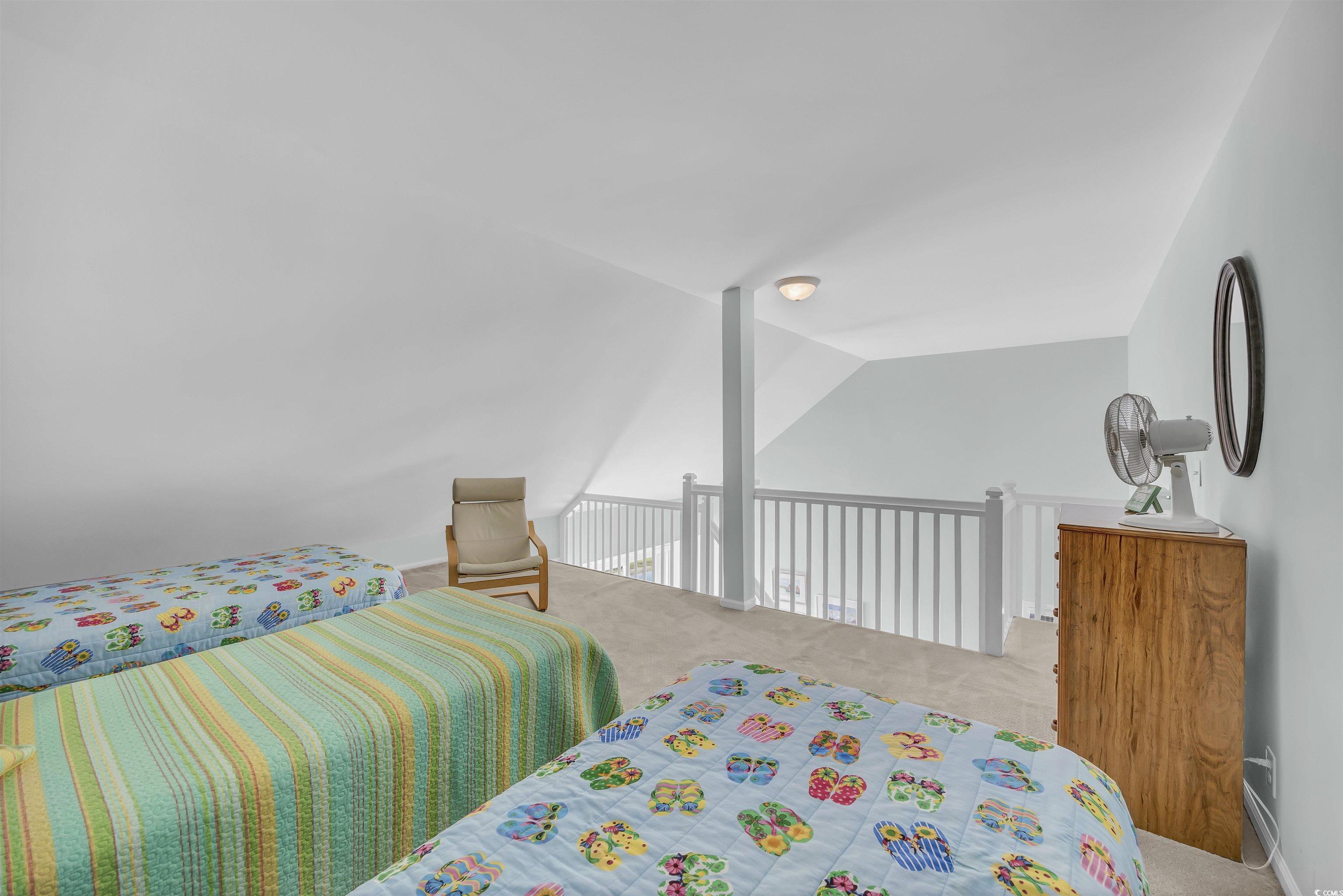 1912 Goose Creek Road Southwest, Unit 4301 Ocean Isle Beach, NC 28469 - Photo 26 of 39 Carpeted bedroom featuring vaulted ceiling