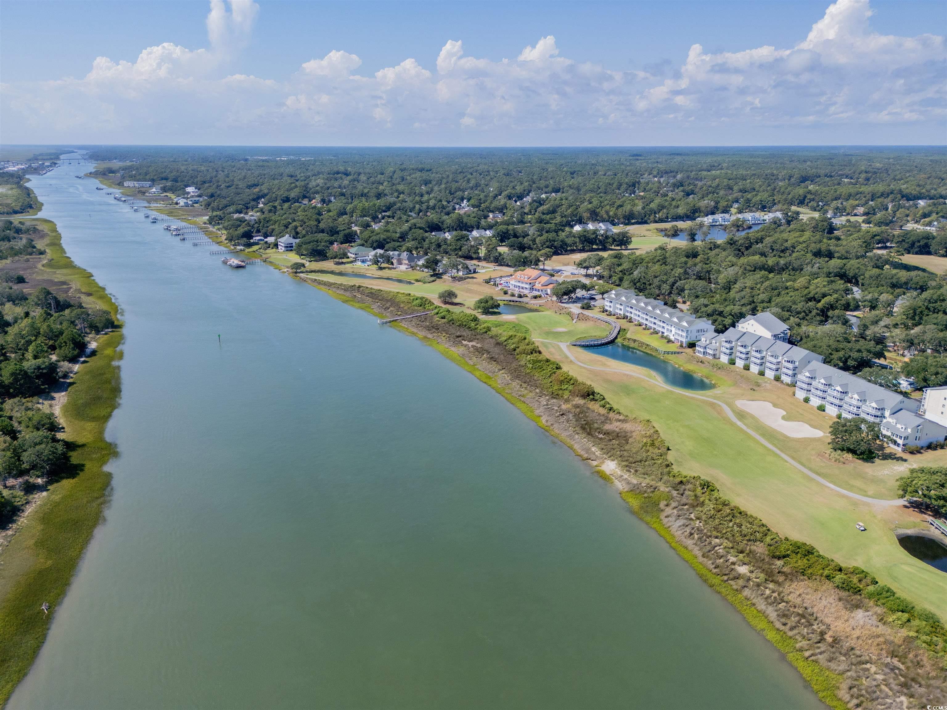 1912 Goose Creek Road Southwest, Unit 4301 Ocean Isle Beach, NC 28469 - Photo 31 of 39 Drone / aerial view of a nearby body of water and a golf course