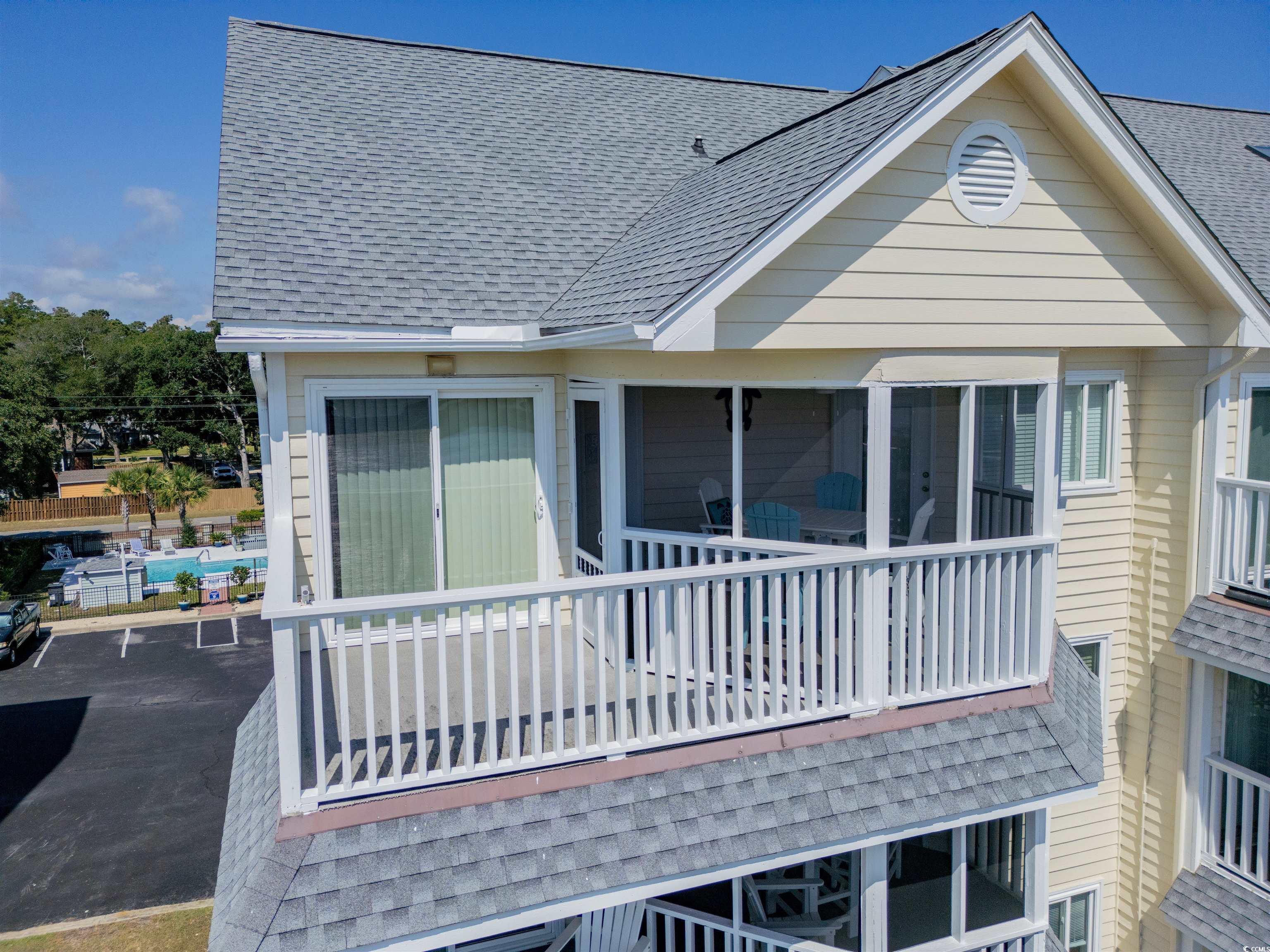1912 Goose Creek Road Southwest, Unit 4301 Ocean Isle Beach, NC 28469 - Photo 37 of 39 Rear view of property featuring a shingled roof