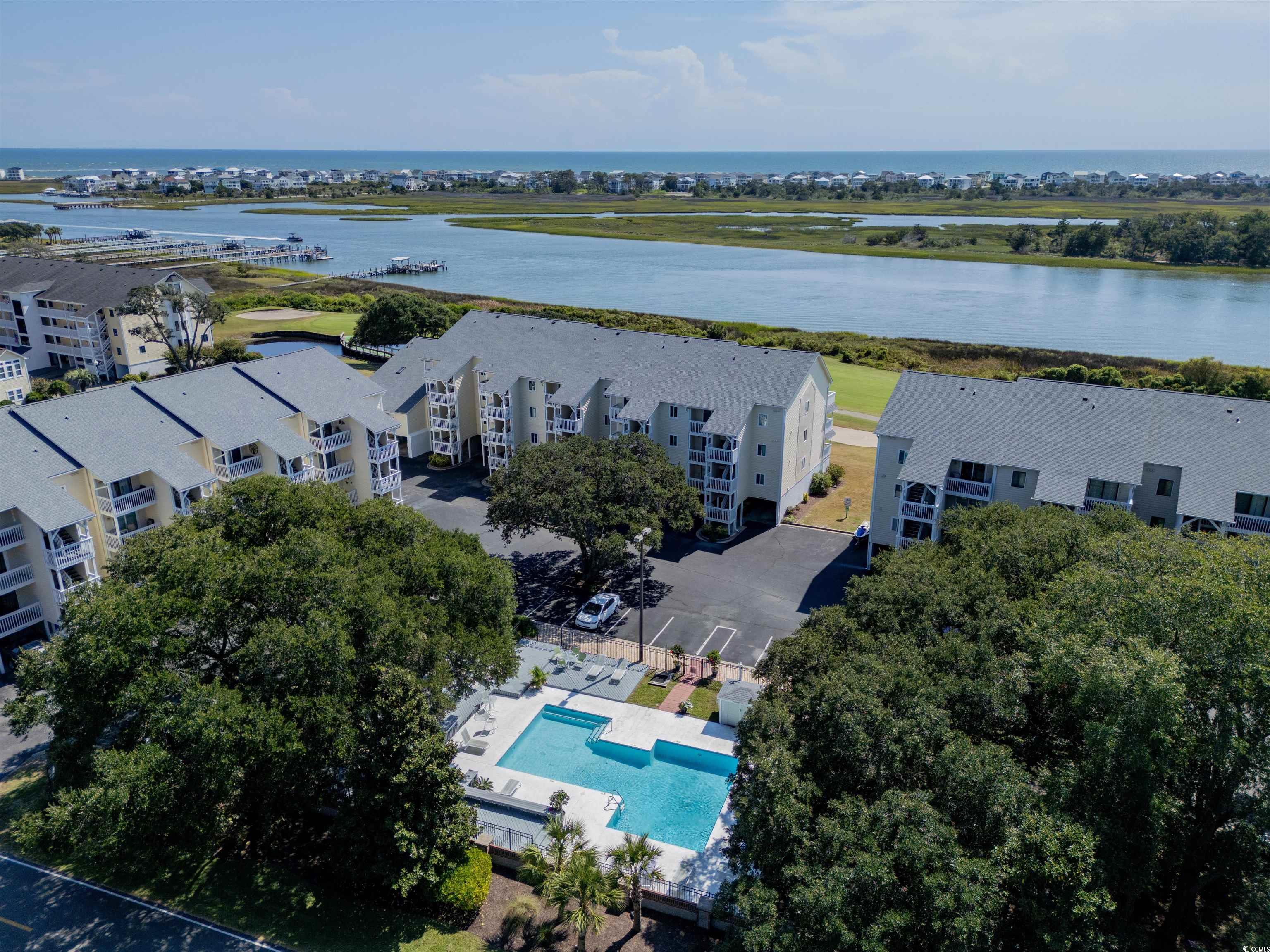1912 Goose Creek Road Southwest, Unit 4301 Ocean Isle Beach, NC 28469 - Photo 39 of 39 Aerial view of a nearby body of water and a pool