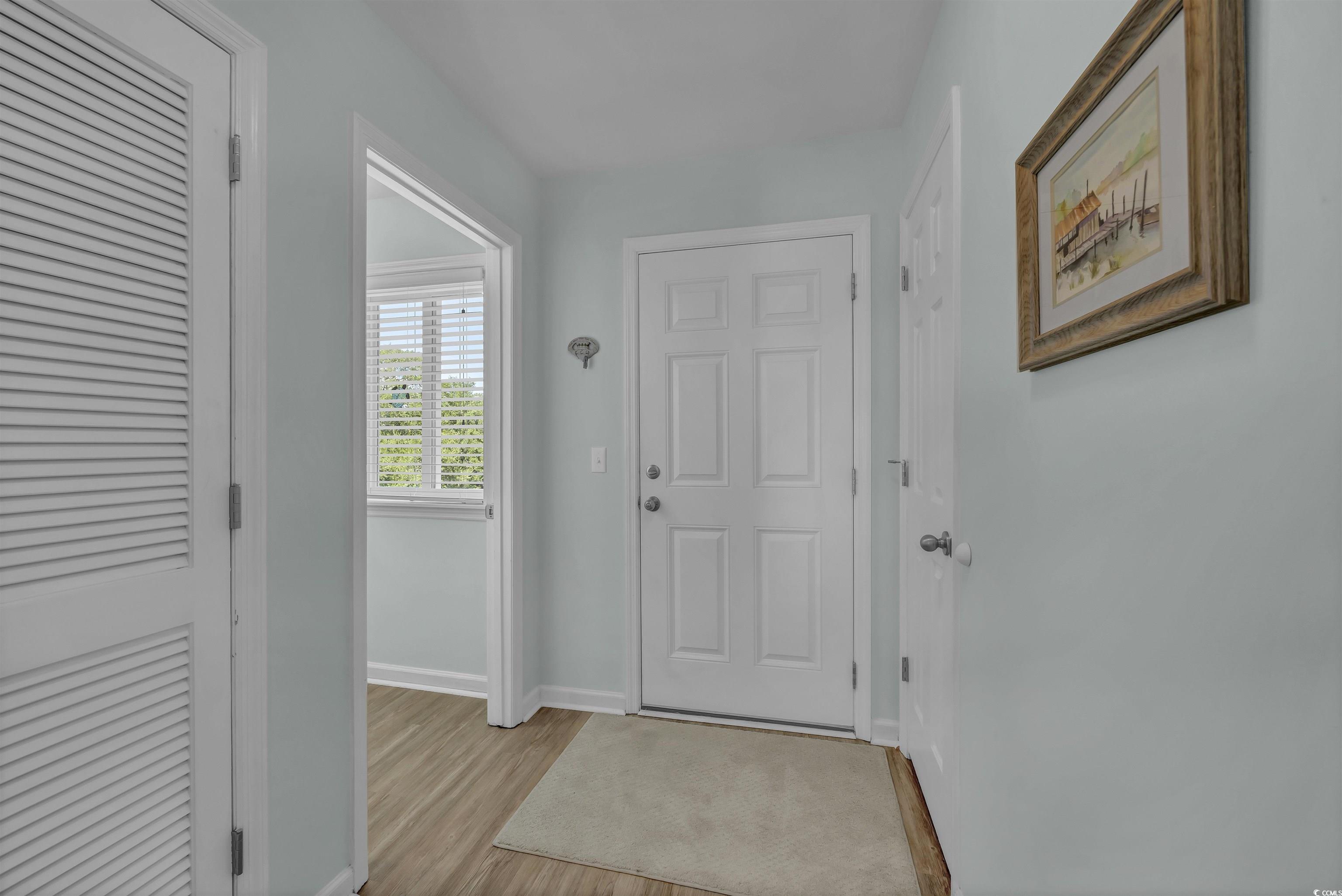 1912 Goose Creek Road Southwest, Unit 4301 Ocean Isle Beach, NC 28469 - Photo 4 of 39 Foyer entrance with baseboards and light wood finished floors