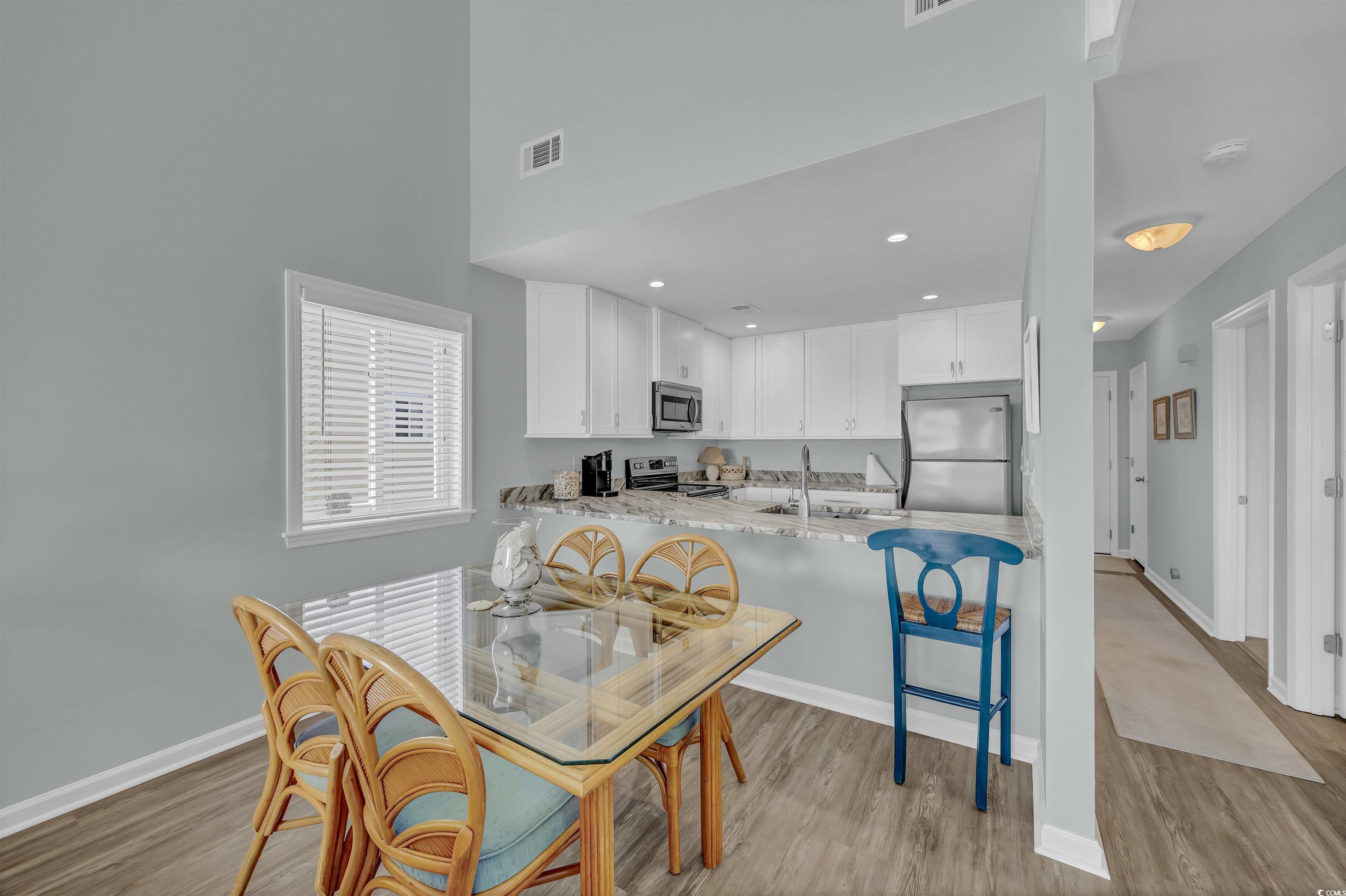 1912 Goose Creek Road Southwest, Unit 4301 Ocean Isle Beach, NC 28469 - Photo 7 of 39 Dining room with light wood-type flooring and recessed lighting