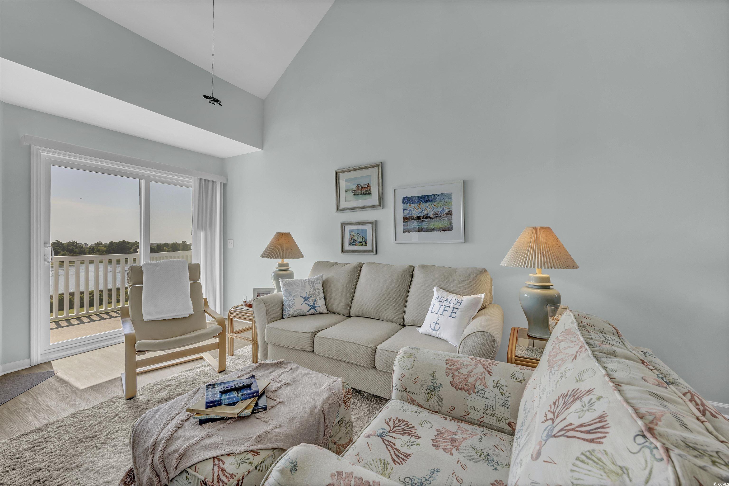 1912 Goose Creek Road Southwest, Unit 4301 Ocean Isle Beach, NC 28469 - Photo 8 of 39 Living area featuring high vaulted ceiling and wood finished floors
