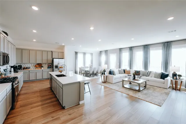 a kitchen with a dining table chairs and kitchen view