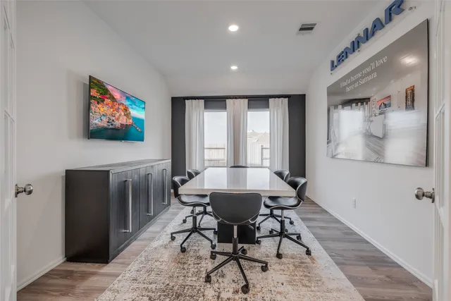 a bedroom with furniture and a large window