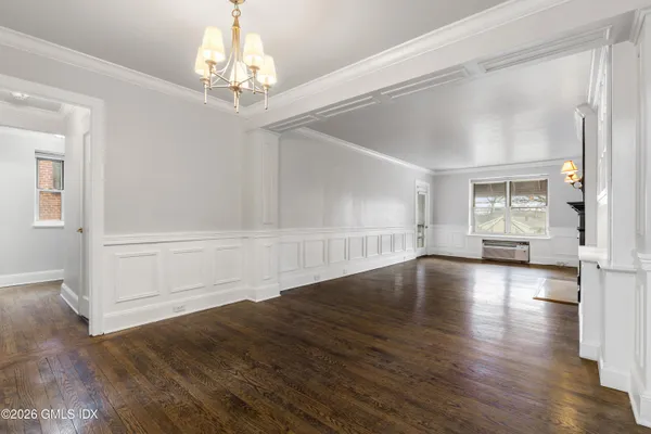 a view of a livingroom with a flat screen tv wooden floor and a fireplace