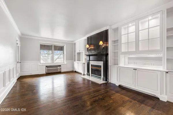 a living room with fireplace and a wooden floor