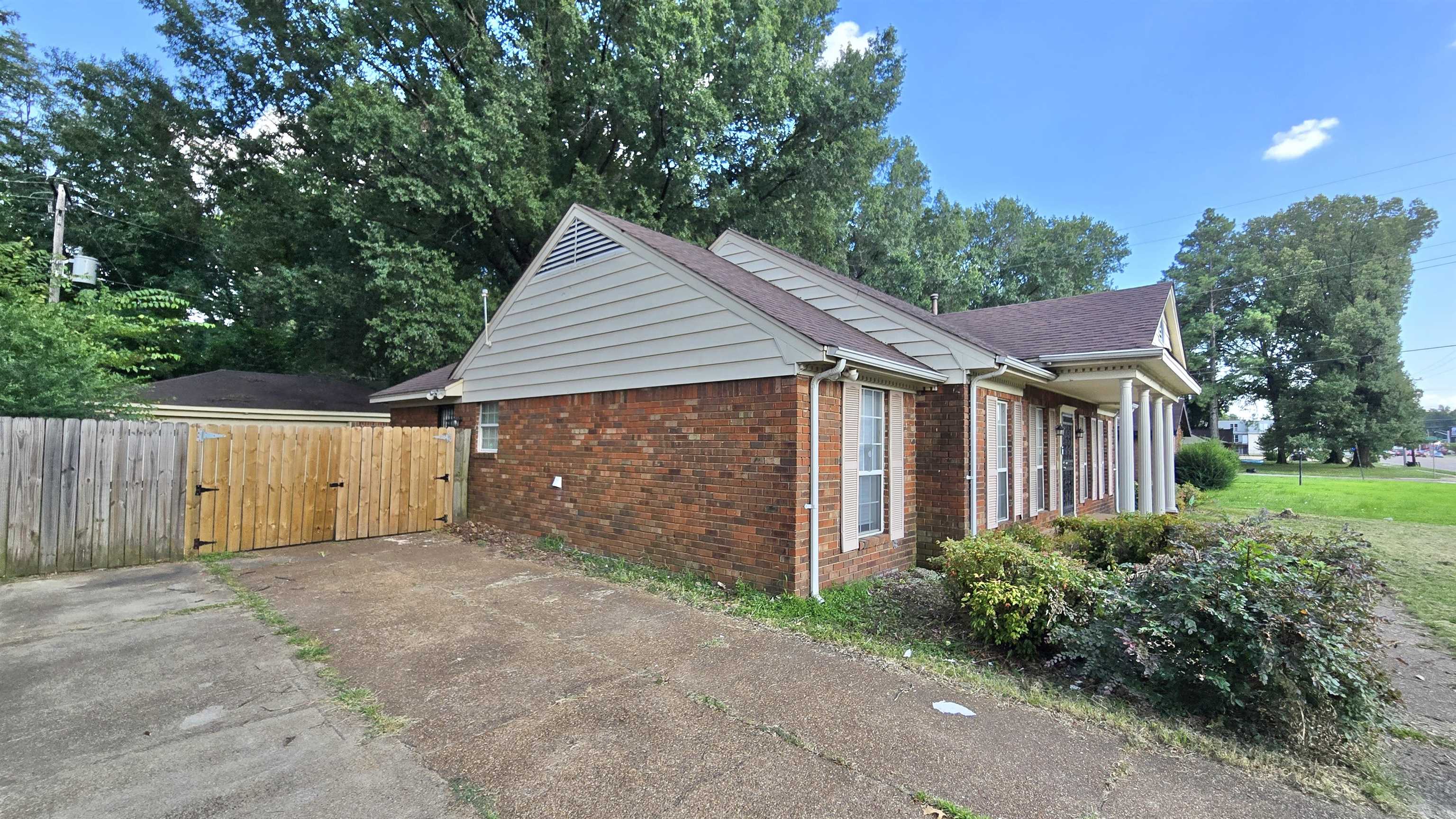 3068 South Mendenhall Road Memphis, TN 38115 - Photo 24 of 26 View of side of home featuring brick siding, a gate, and a shingled roof