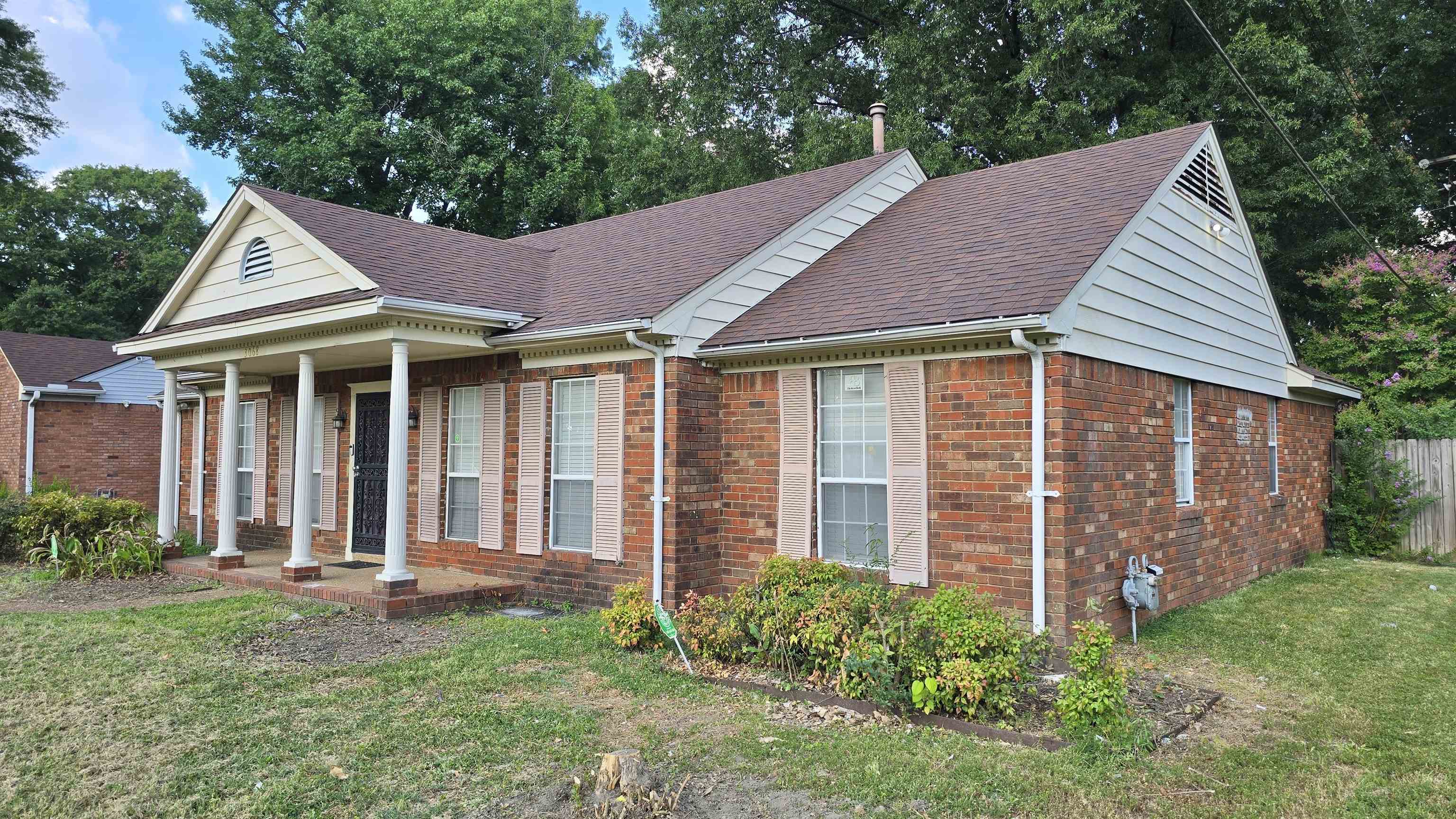 3068 South Mendenhall Road Memphis, TN 38115 - Photo 25 of 26 View of front of home with a shingled roof, brick siding, and covered porch