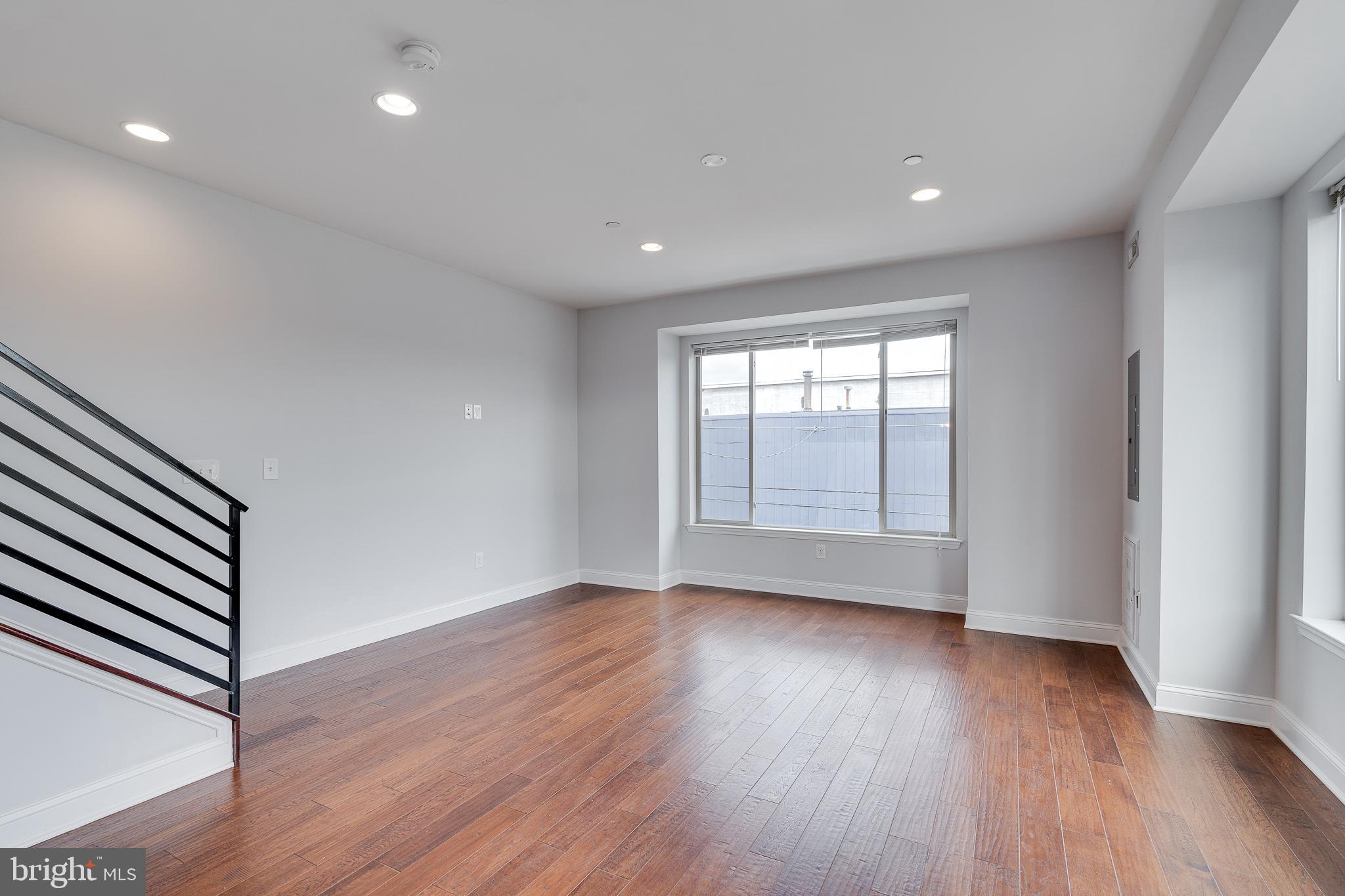 1024 South 19th Street, Unit B Philadelphia, PA 19146 - Photo 7 of 28 wooden floor in an empty room with a window