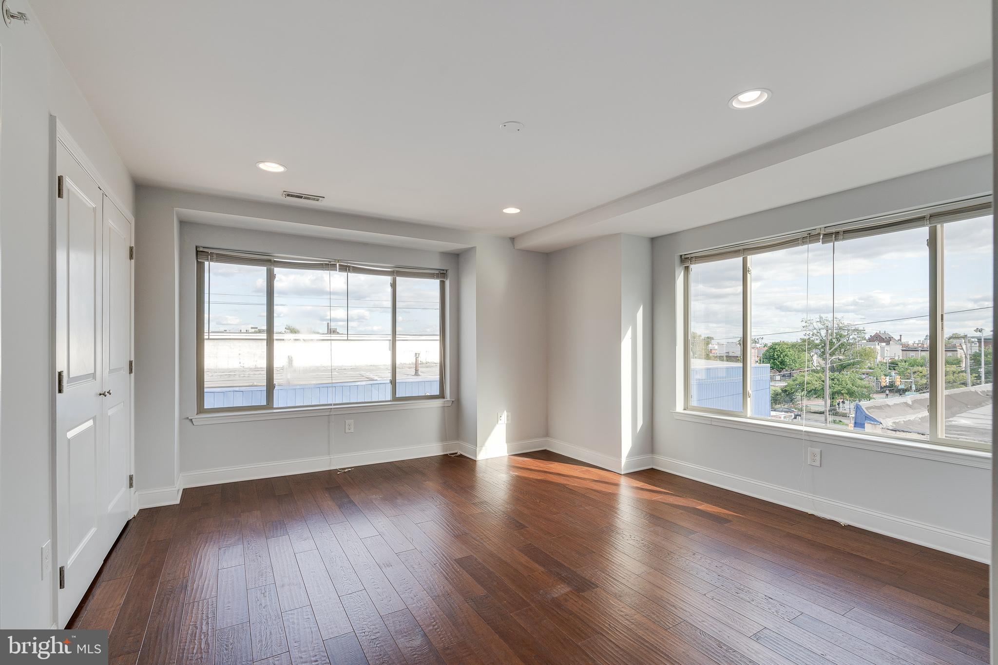 1024 South 19th Street, Unit B Philadelphia, PA 19146 - Photo 9 of 28 a view of an empty room with wooden floor and a window