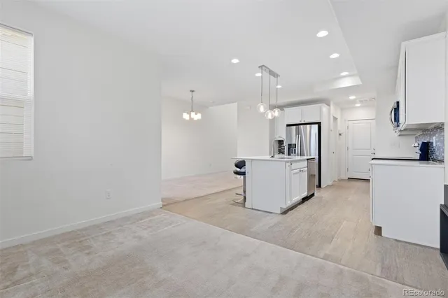 a view of a kitchen with refrigerator and microwave