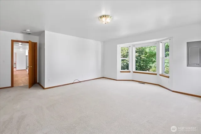 an empty room with windows and closet