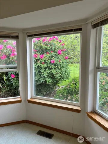 a spacious bathroom with double vanity a window a mirror and a bathtub