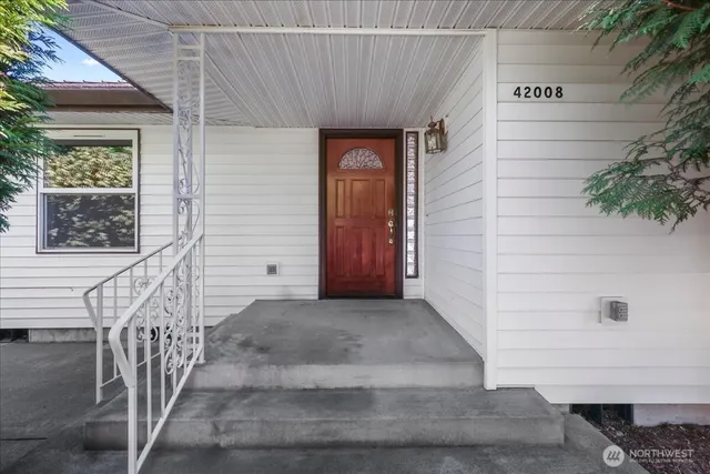 a front view of a house with stairs