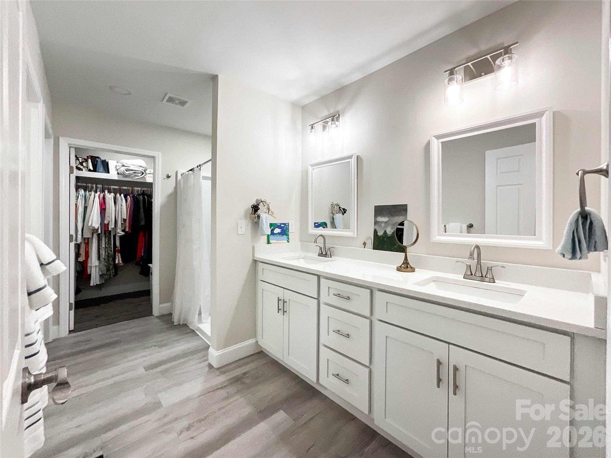 404 White Store Road Wadesboro, NC 28170 - Photo 22 of 38 a spacious bathroom with a double vanity sink and a mirror