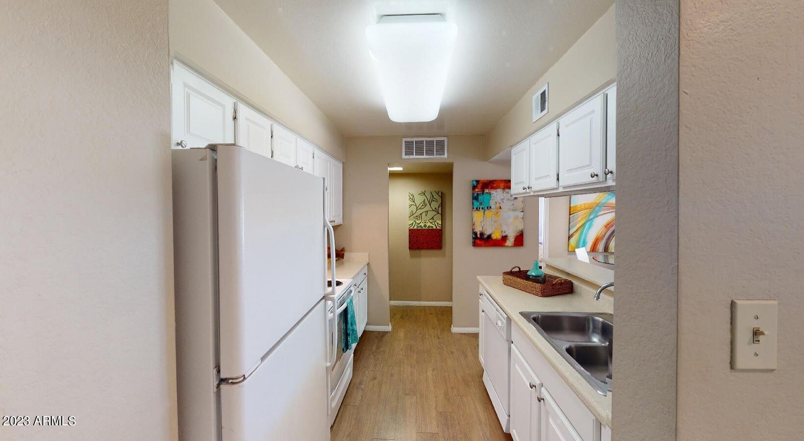 9605 South 48th Street, Unit A3 Phoenix, AZ 85044 - Photo 3 of 11 a kitchen with a refrigerator and a stove