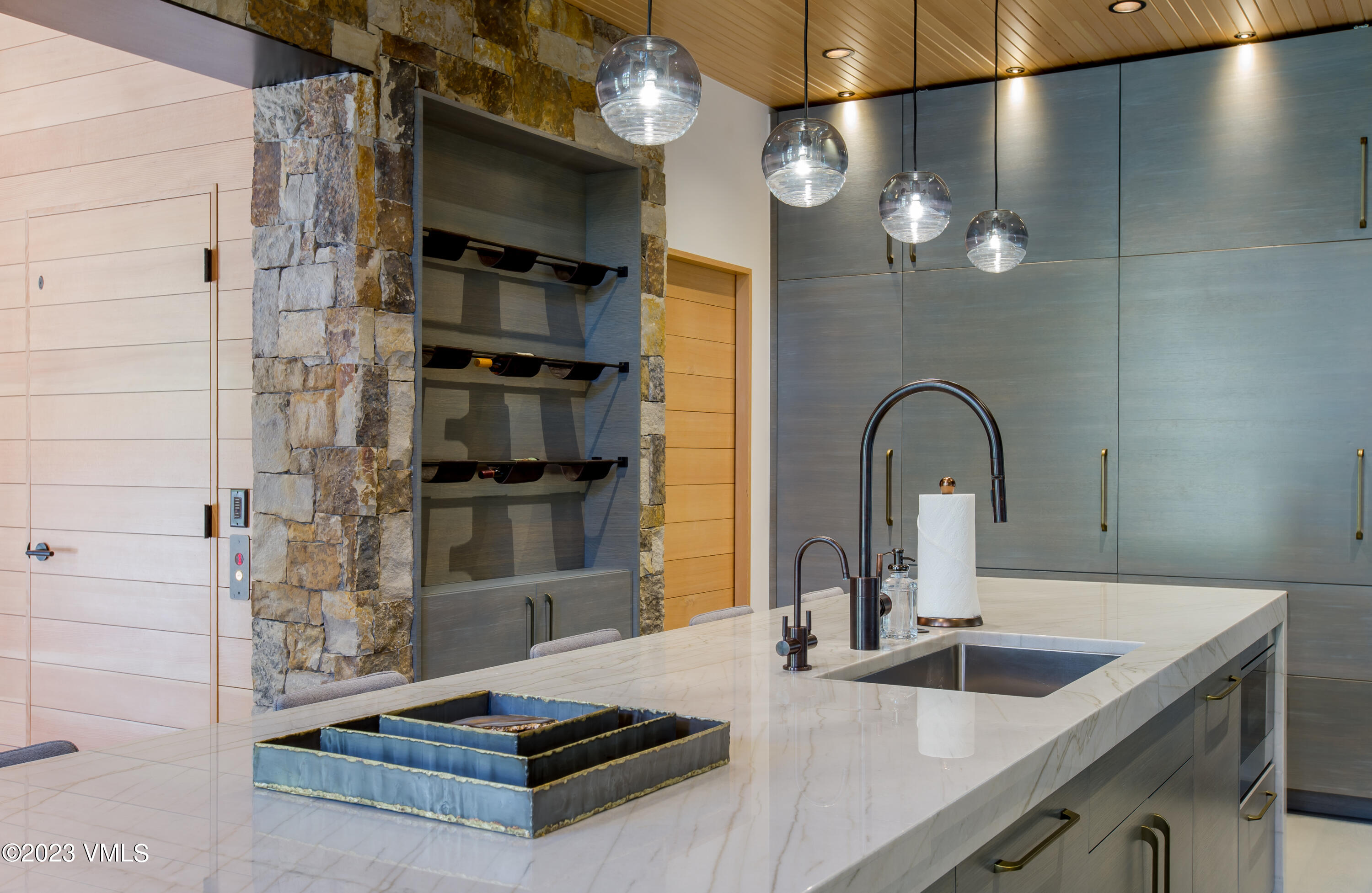 645 West Forest Road Vail, CO 81657 - Photo 12 of 48 a kitchen with sink a refrigerator and microwave