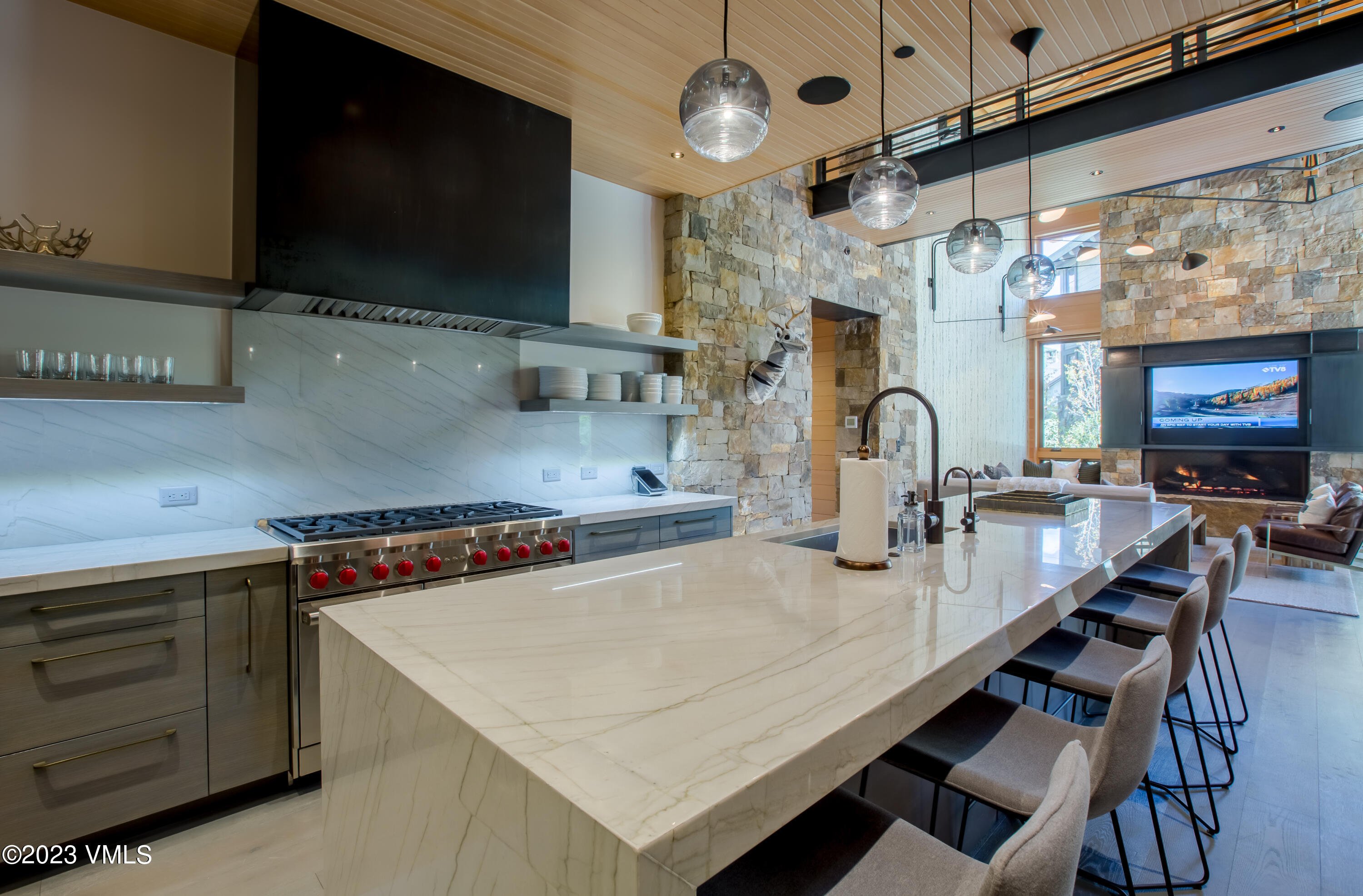 645 West Forest Road Vail, CO 81657 - Photo 14 of 48 a kitchen with stainless steel appliances a stove a sink and a microwave