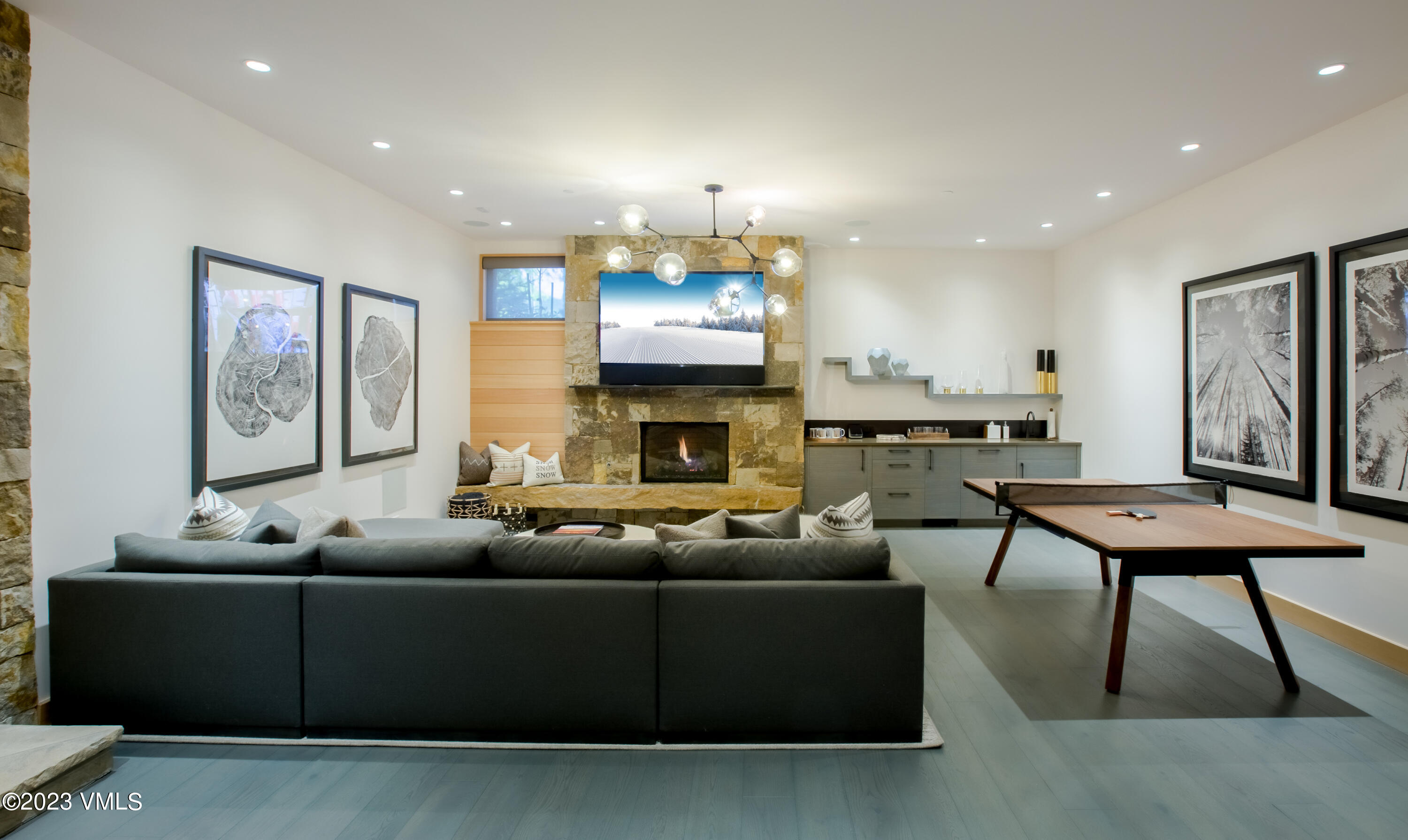 645 West Forest Road Vail, CO 81657 - Photo 18 of 48 a living room with furniture a fireplace and a flat screen tv