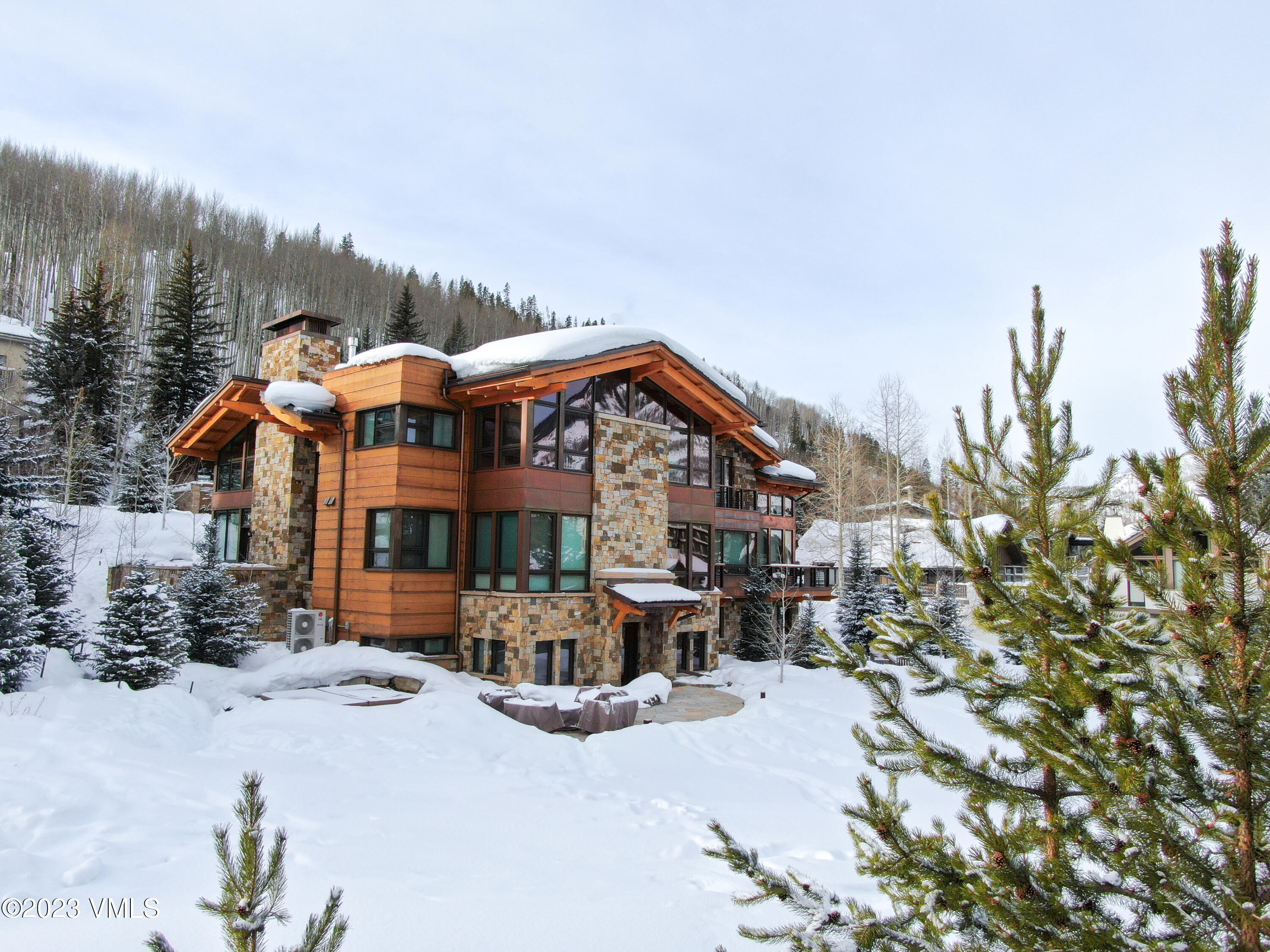 645 West Forest Road Vail, CO 81657 - Photo 2 of 48 a front view of a house with a yard and lake view