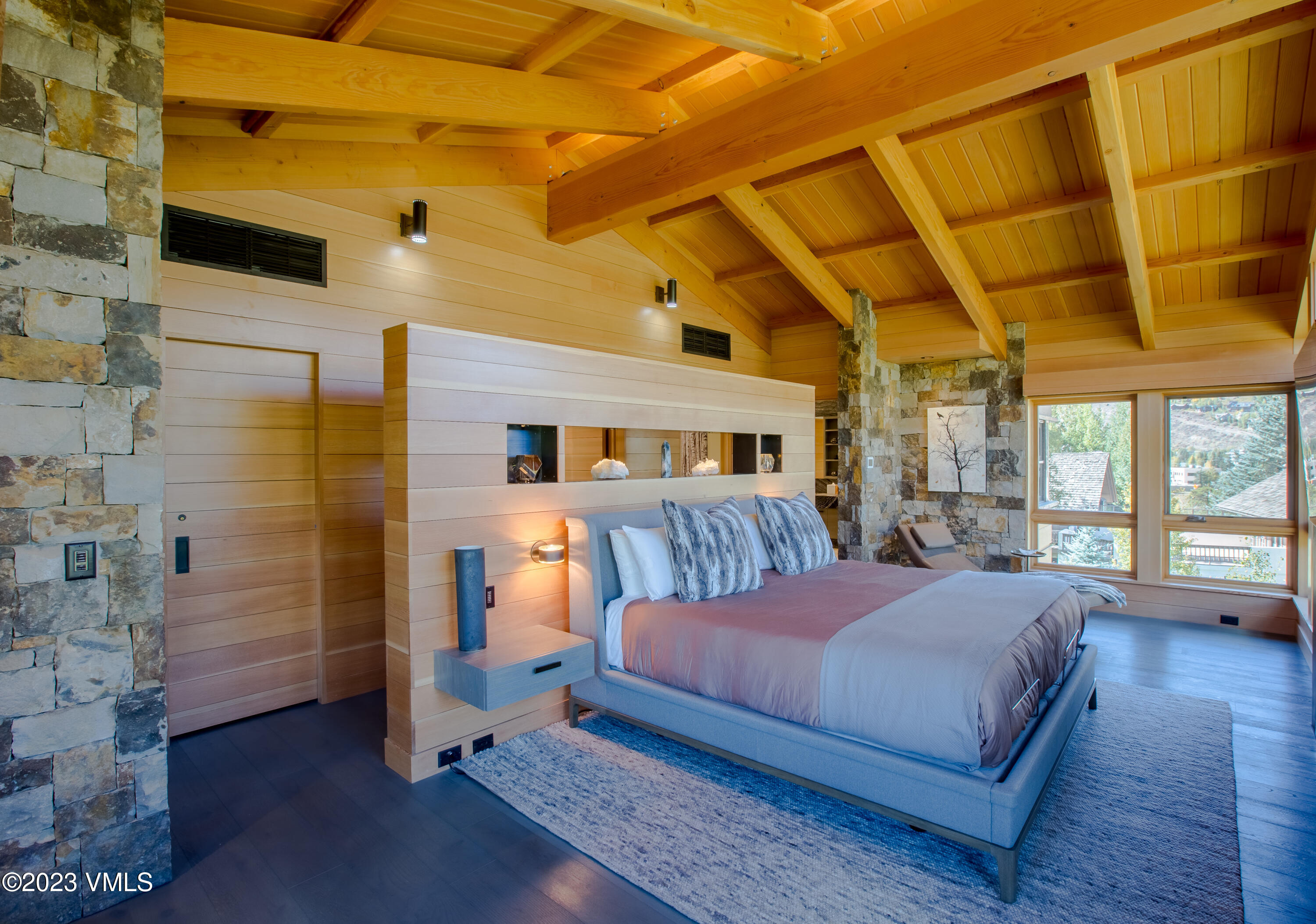 645 West Forest Road Vail, CO 81657 - Photo 25 of 48 a bedroom with a bed and wooden floor