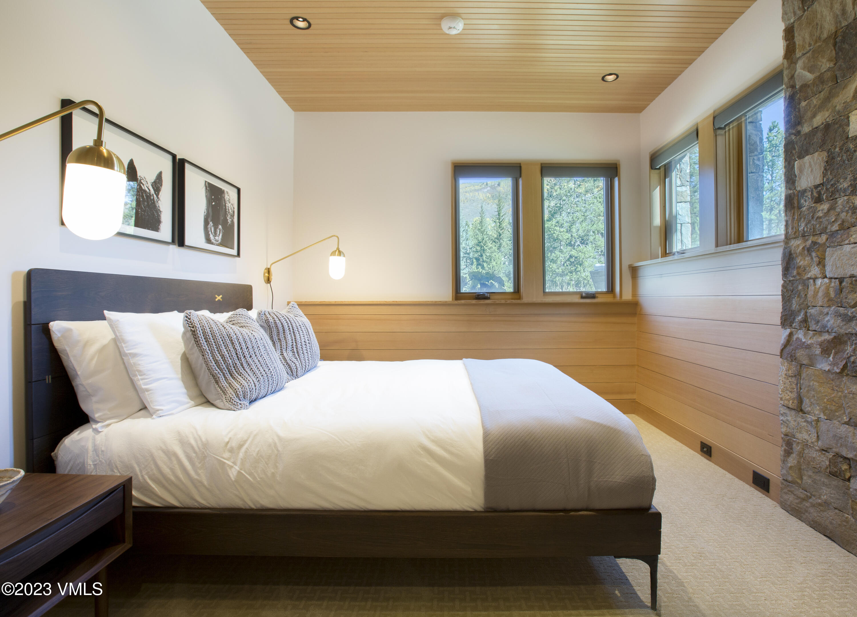 645 West Forest Road Vail, CO 81657 - Photo 33 of 48 a bedroom with a large bed and wooden floor