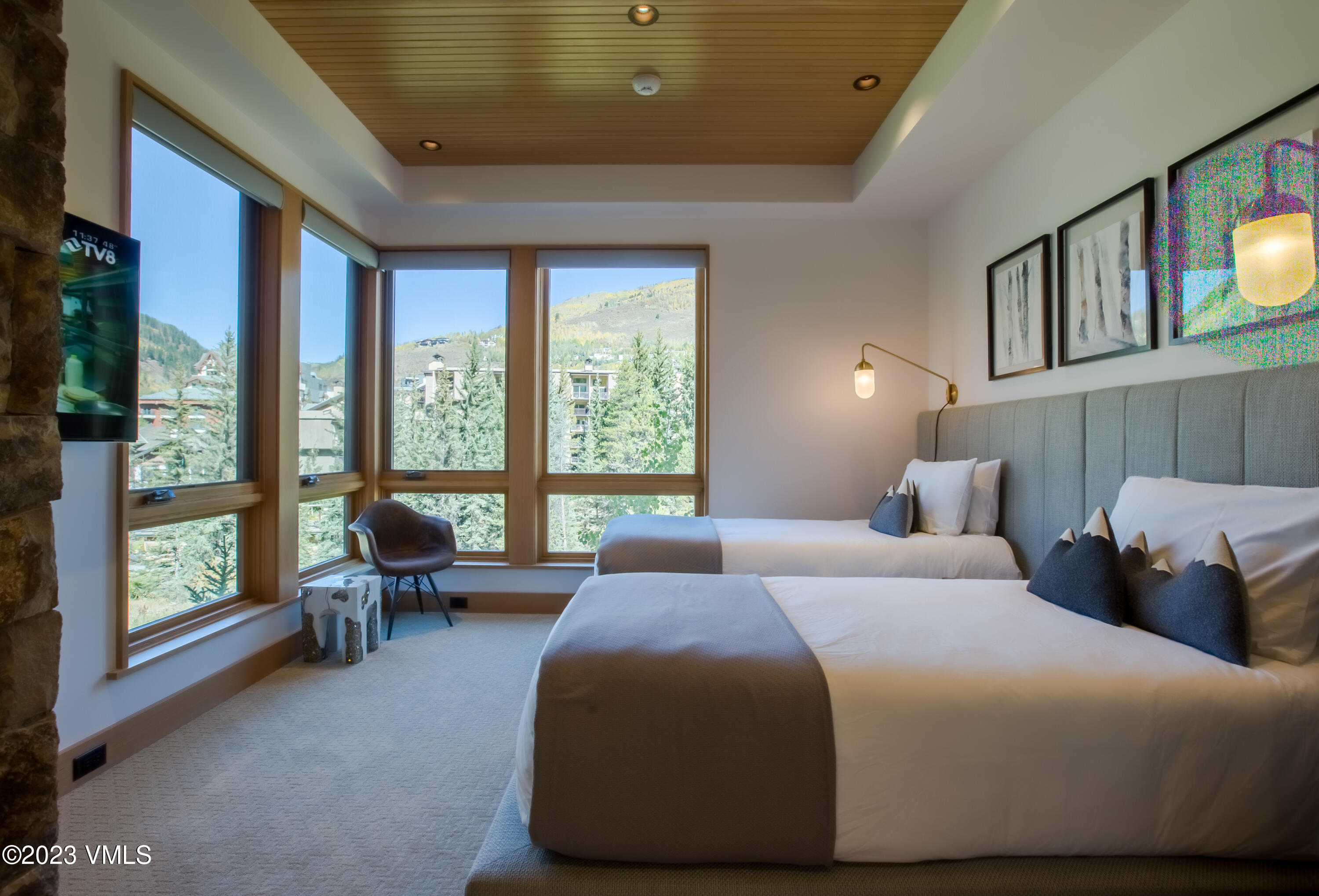 645 West Forest Road Vail, CO 81657 - Photo 36 of 48 a spacious bedroom with a bed and a large window with balcony view