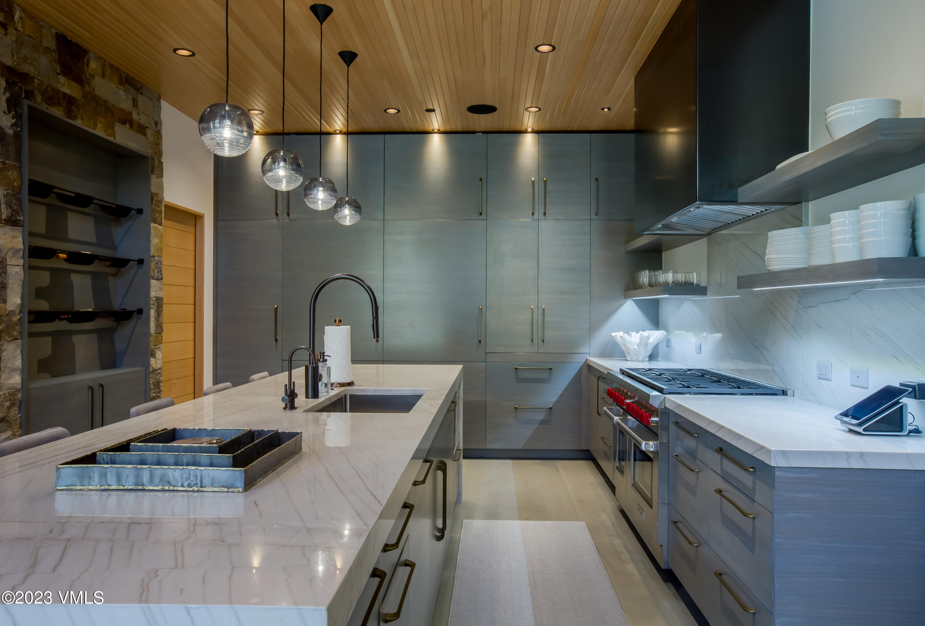 645 West Forest Road Vail, CO 81657 - Photo 10 of 48 a kitchen with stainless steel appliances granite countertop a sink and a stove