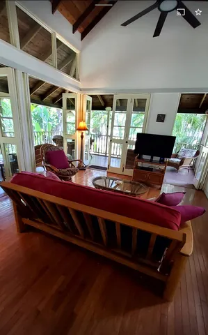 a living room with furniture and a floor to ceiling window