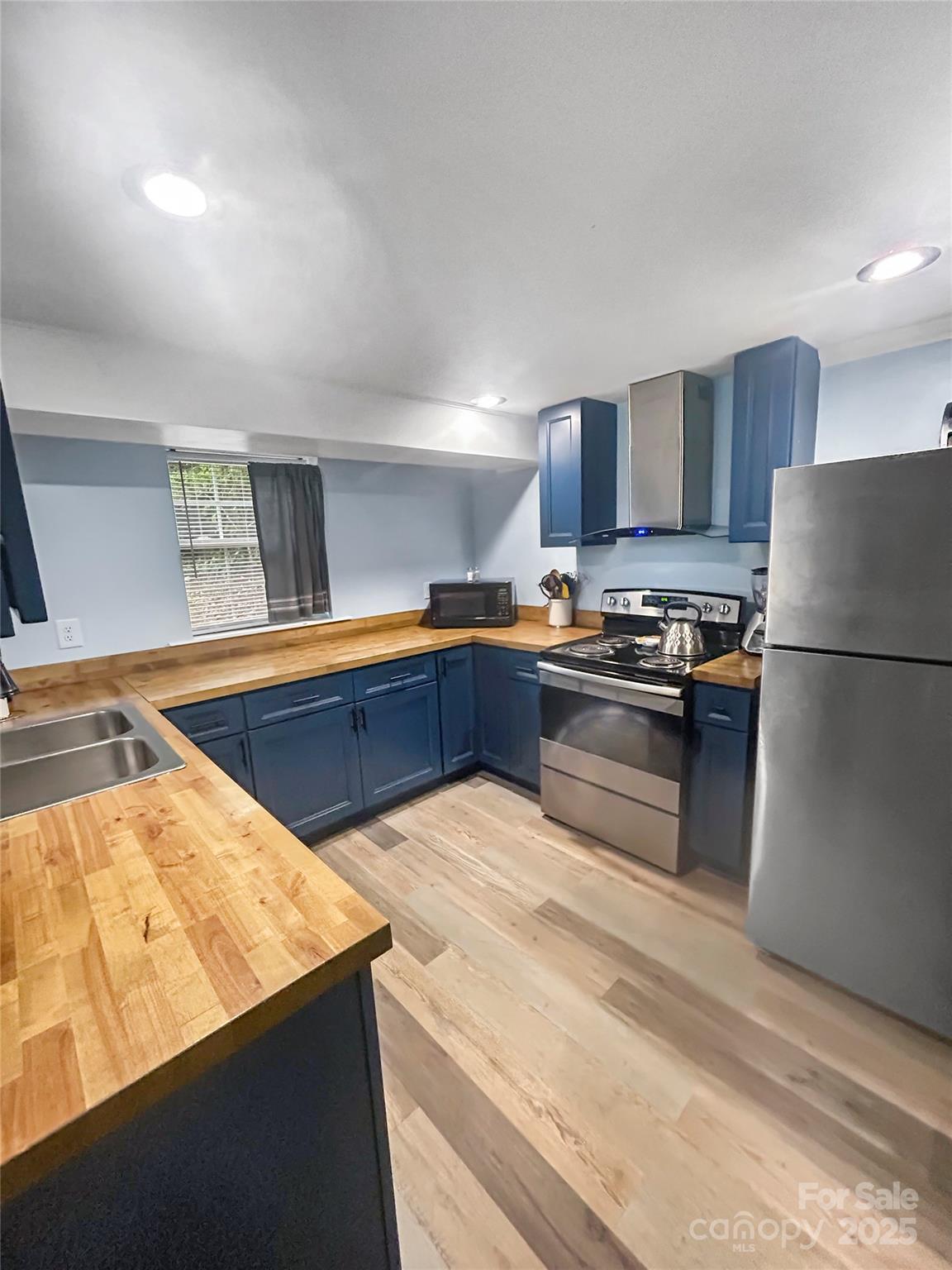 754 South 5th Street Albemarle, NC 28001 - Photo 6 of 13 a kitchen with stainless steel appliances granite countertop a sink stove and refrigerator