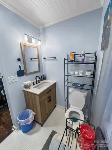 a view of bathroom with a sink toilet and a mirror