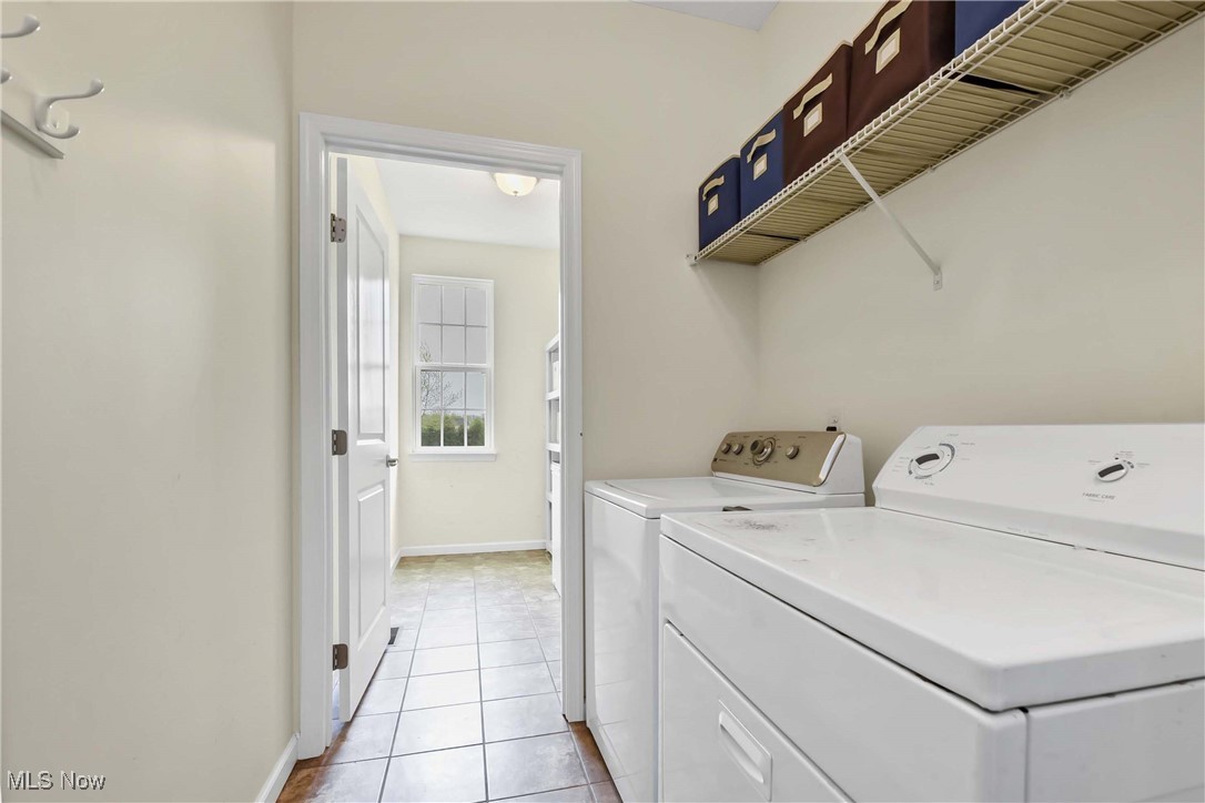 4614 Ridgestone Way Medina, OH 44256 - Photo 28 of 32 Clothes washing area featuring washer and dryer, light tile patterned floors, laundry area, and baseboards