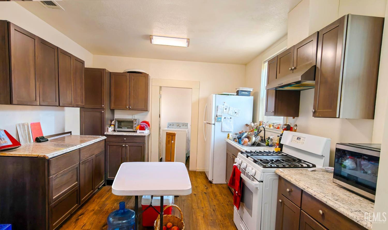 Undisclosed Address Visalia, CA 93291 - Photo 12 of 14 a kitchen with a stove a sink and a refrigerator
