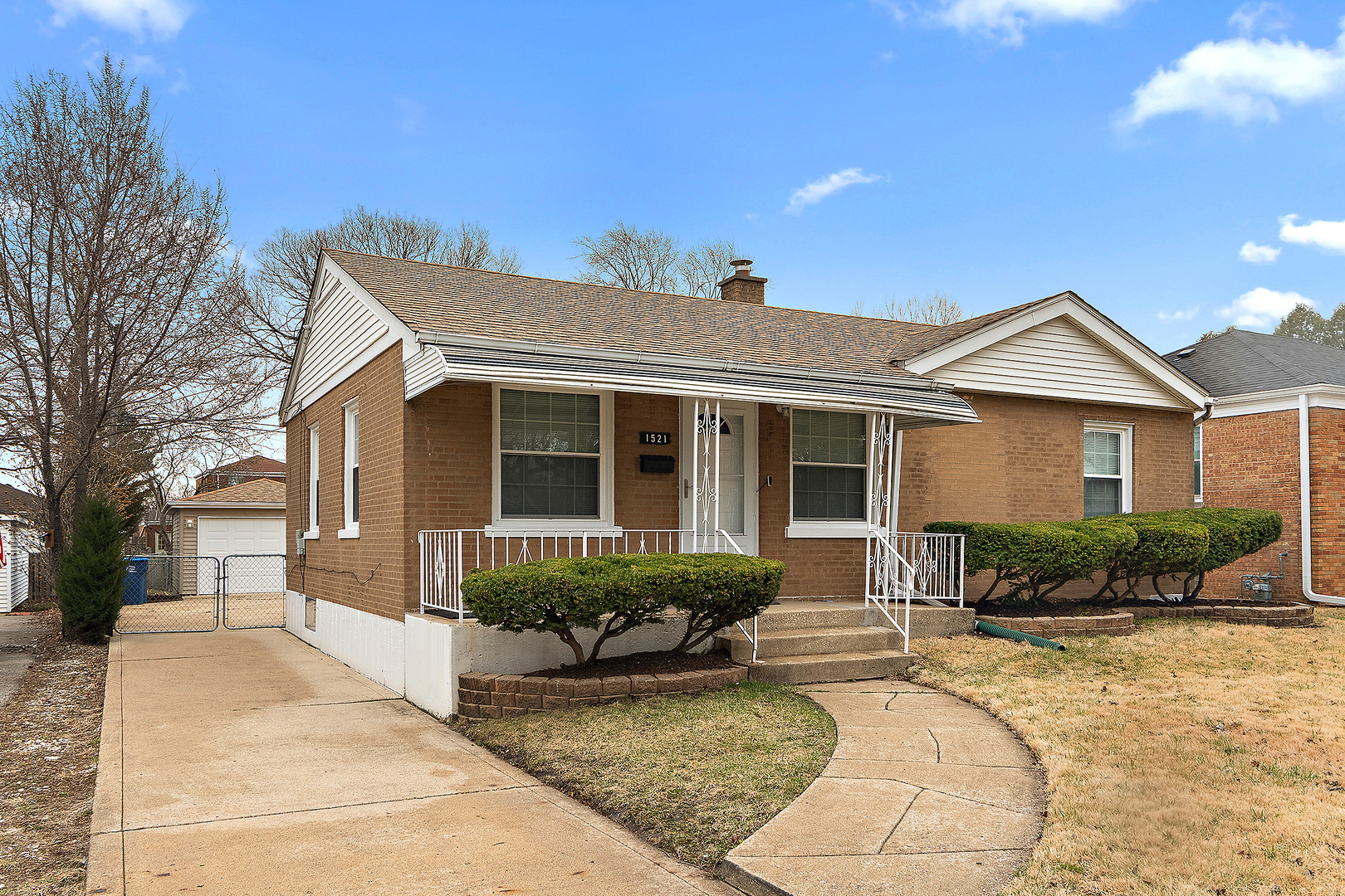 a front view of a house with a yard and outdoor seating