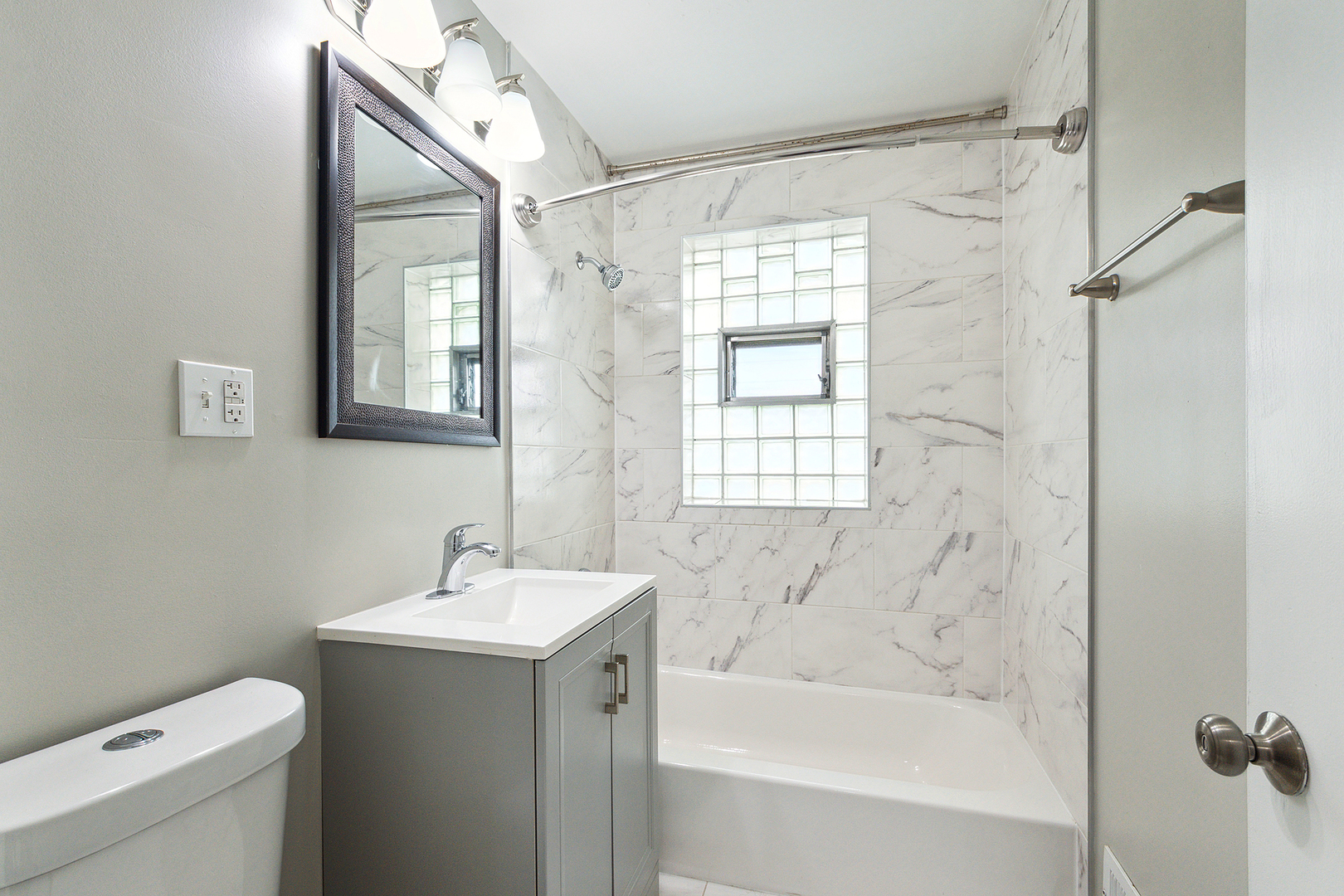 1521 North Wolf Road Berkeley, IL 60163 - Photo 12 of 16 a bathroom with a sink mirror toilet and bathtub