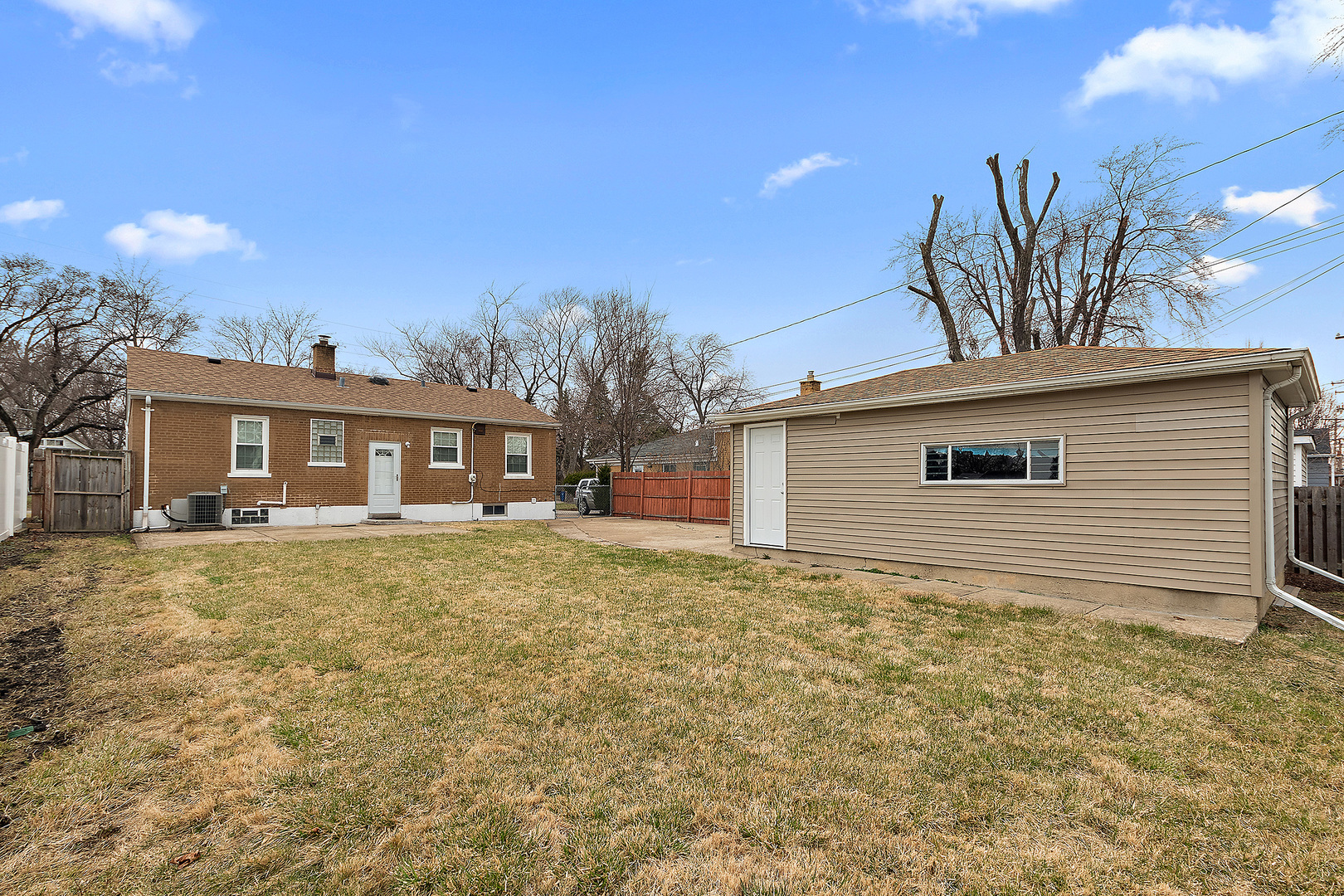 1521 North Wolf Road Berkeley, IL 60163 - Photo 15 of 16 a front view of a house with a garden