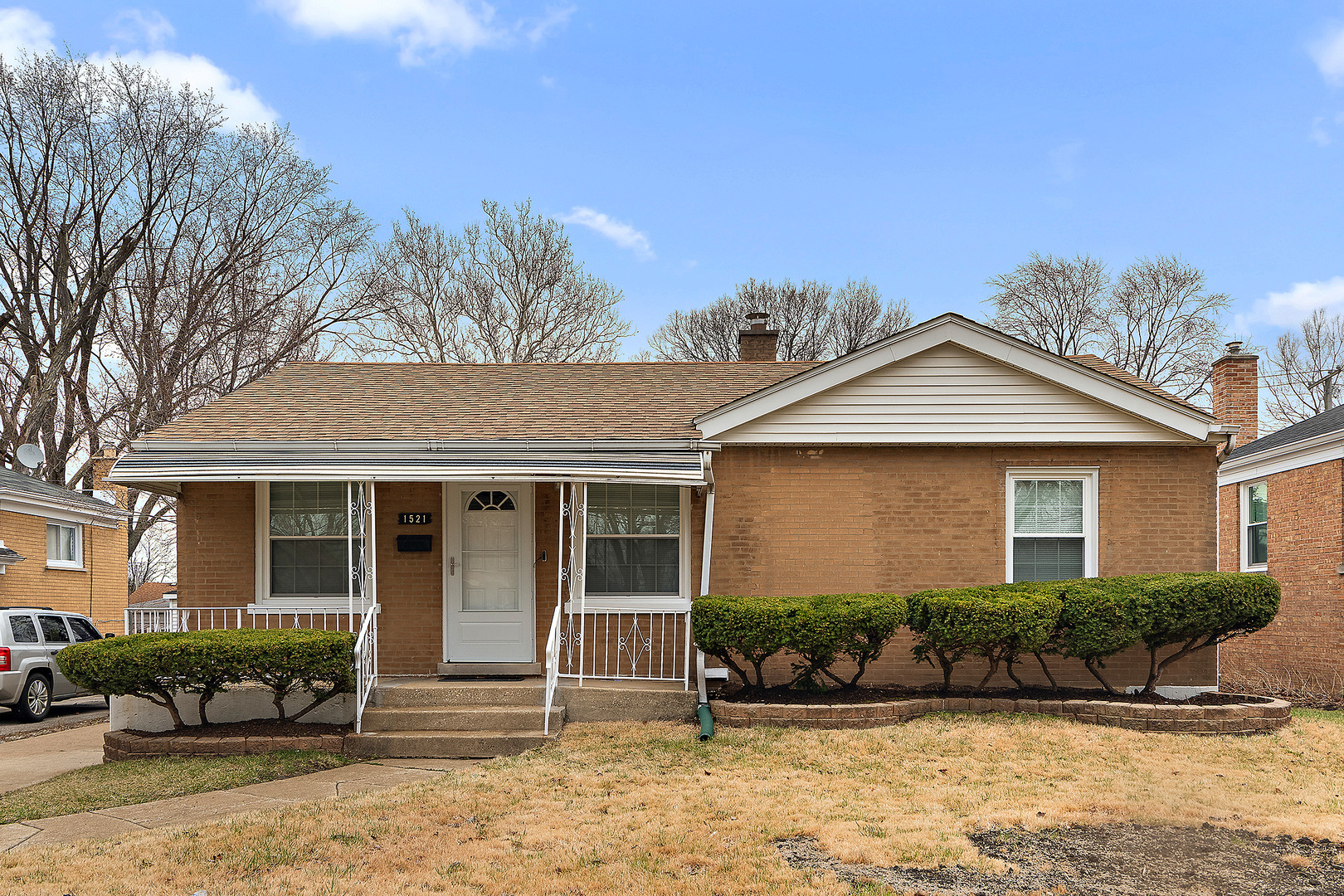 1521 North Wolf Road Berkeley, IL 60163 - Photo 2 of 16 a front view of a house with a yard