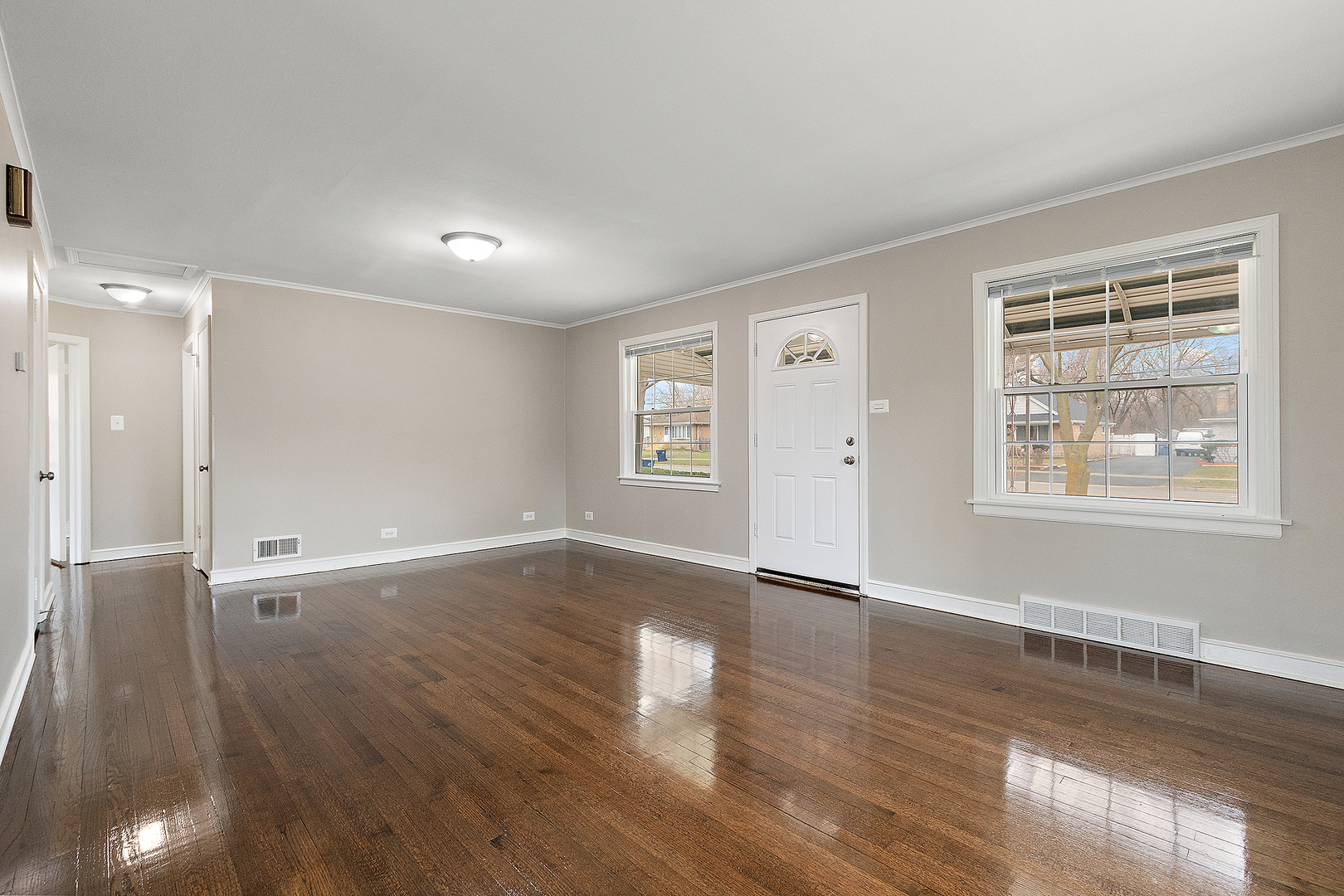 1521 North Wolf Road Berkeley, IL 60163 - Photo 3 of 16 an empty room with wooden floor and windows