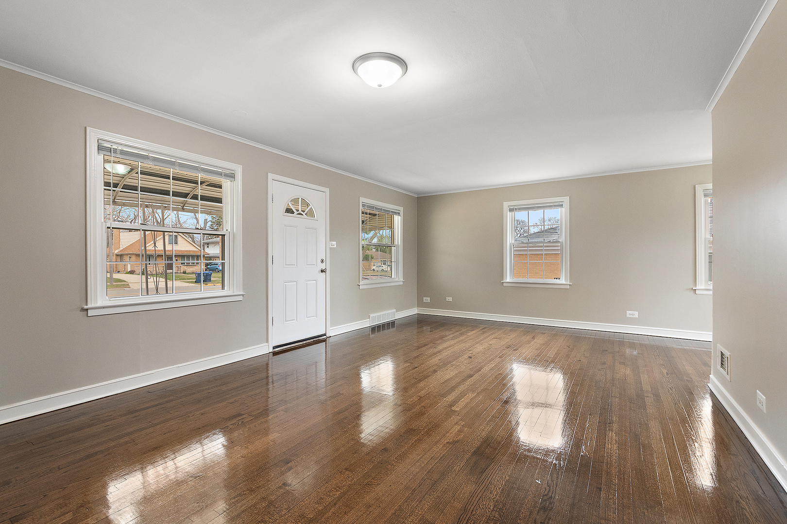1521 North Wolf Road Berkeley, IL 60163 - Photo 4 of 16 a view of an empty room with wooden floor and a window