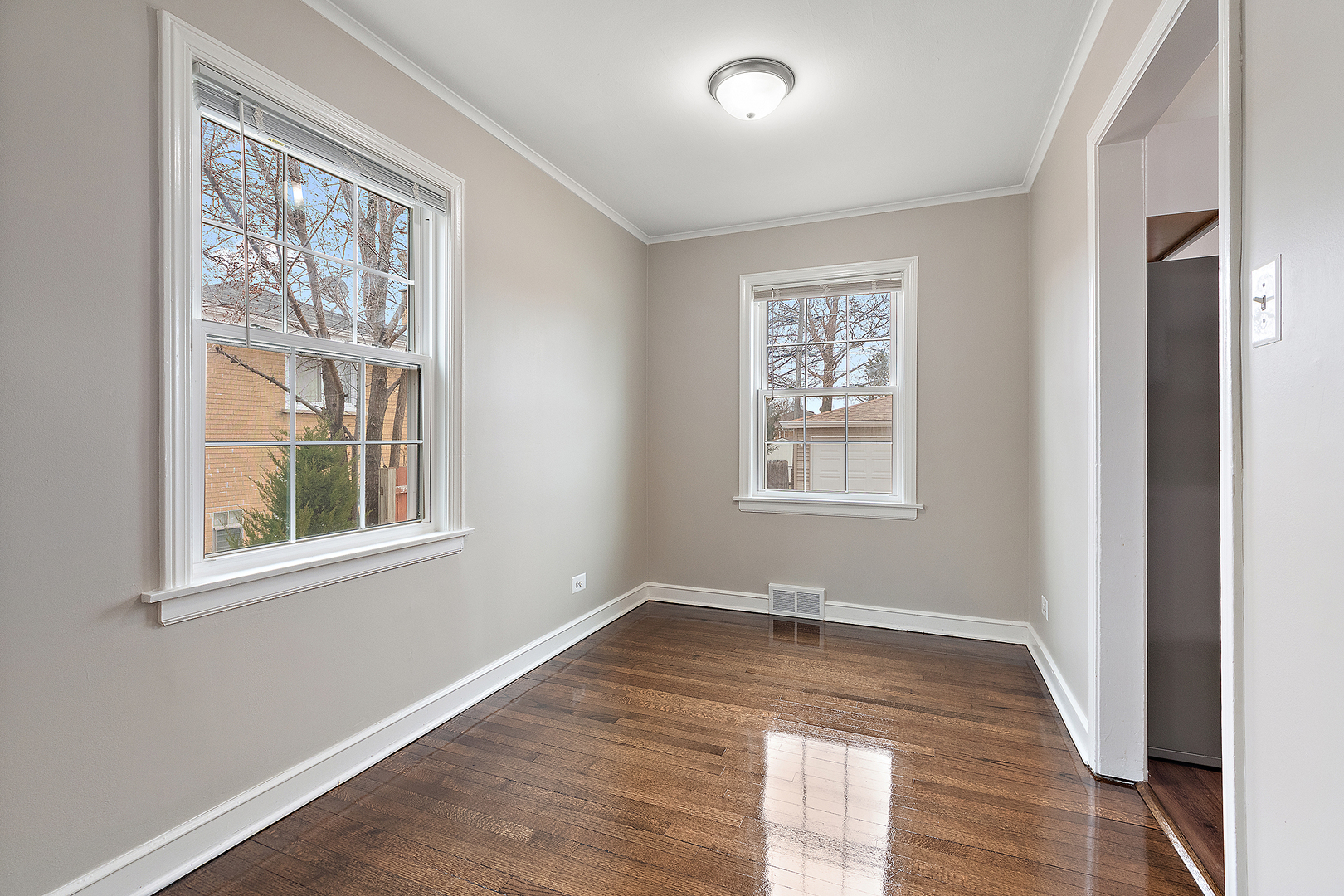 1521 North Wolf Road Berkeley, IL 60163 - Photo 6 of 16 an empty room with wooden floor and windows