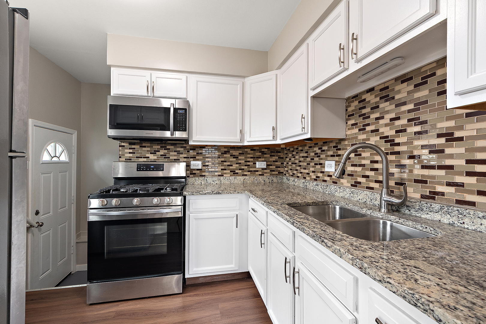 1521 North Wolf Road Berkeley, IL 60163 - Photo 7 of 16 a kitchen with stainless steel appliances granite countertop a sink stove oven a sink and dishwasher a refrigerator with wooden cabinets