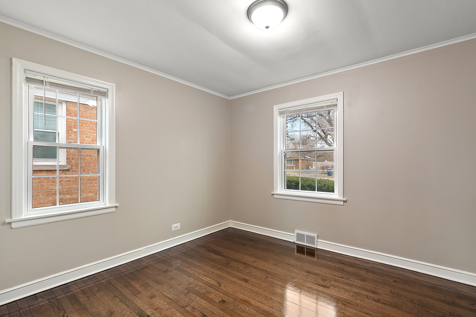 1521 North Wolf Road Berkeley, IL 60163 - Photo 9 of 16 an empty room with wooden floor and windows