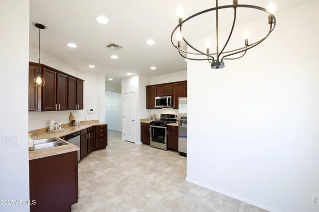 a kitchen with stainless steel appliances granite countertop a stove and a microwave