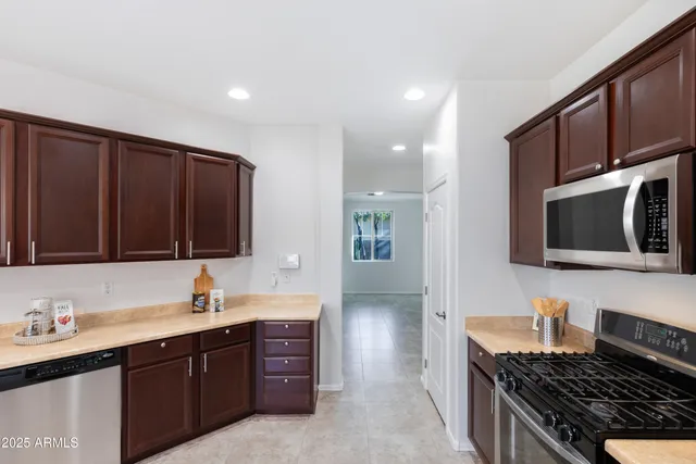 a kitchen with stainless steel appliances a stove sink and cabinets