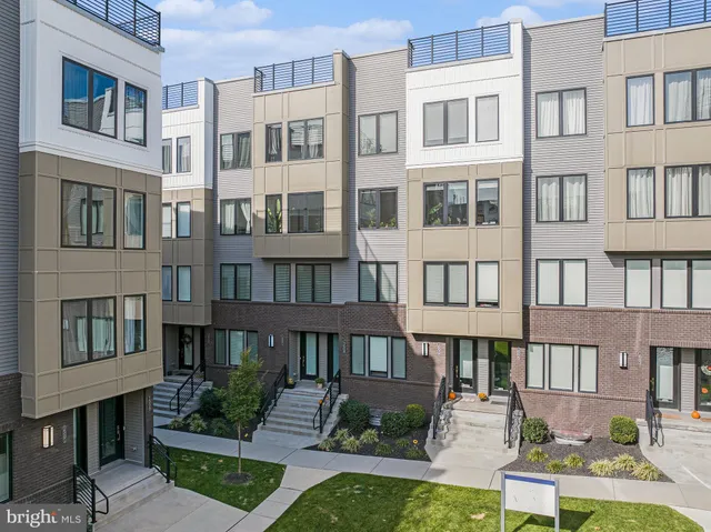 a front view of a building with a garden and plants
